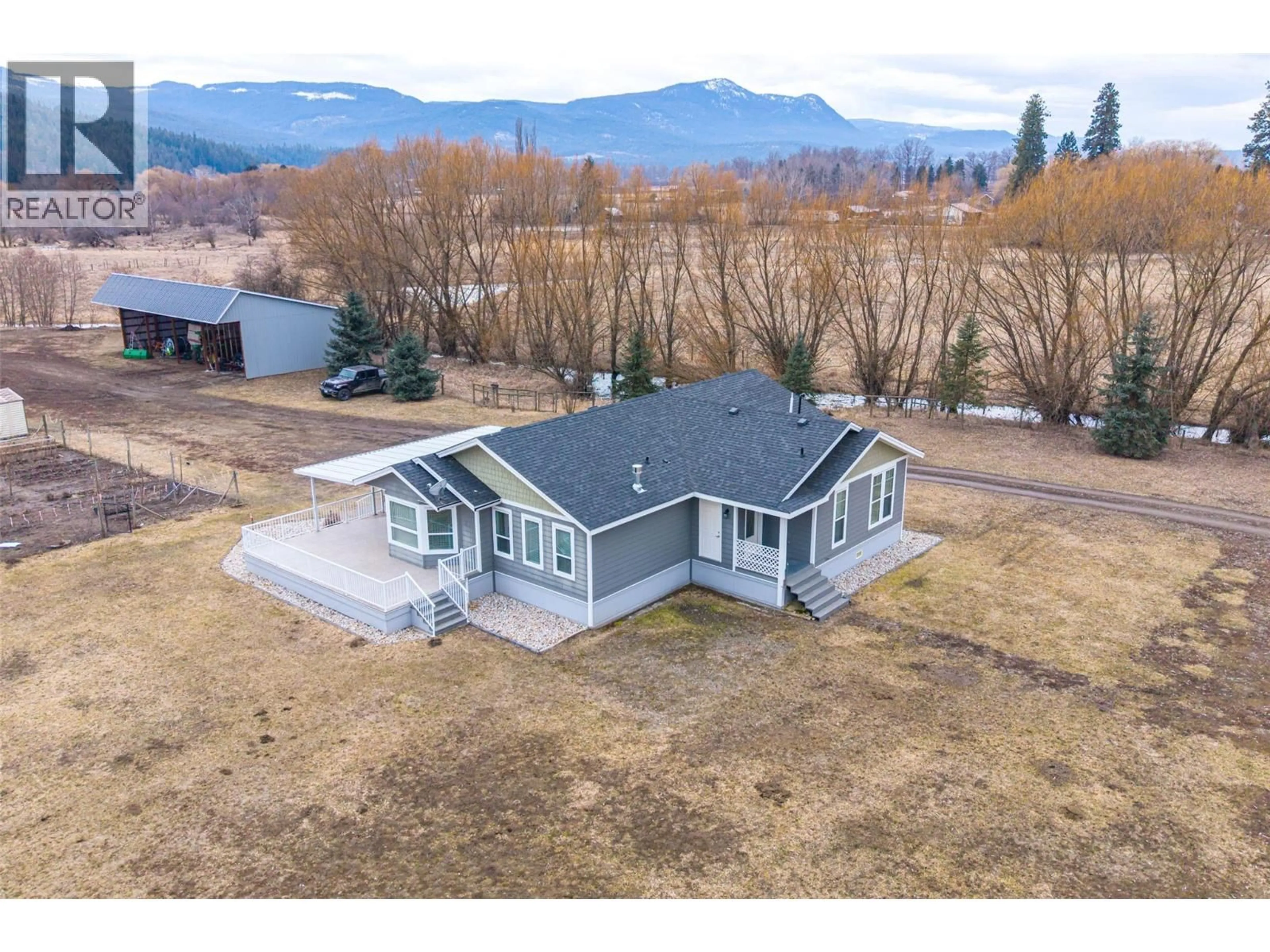 A pic from outside/outdoor area/front of a property/back of a property/a pic from drone, mountain view for 64 BLOOM ROAD, Lumby British Columbia V0E2G7