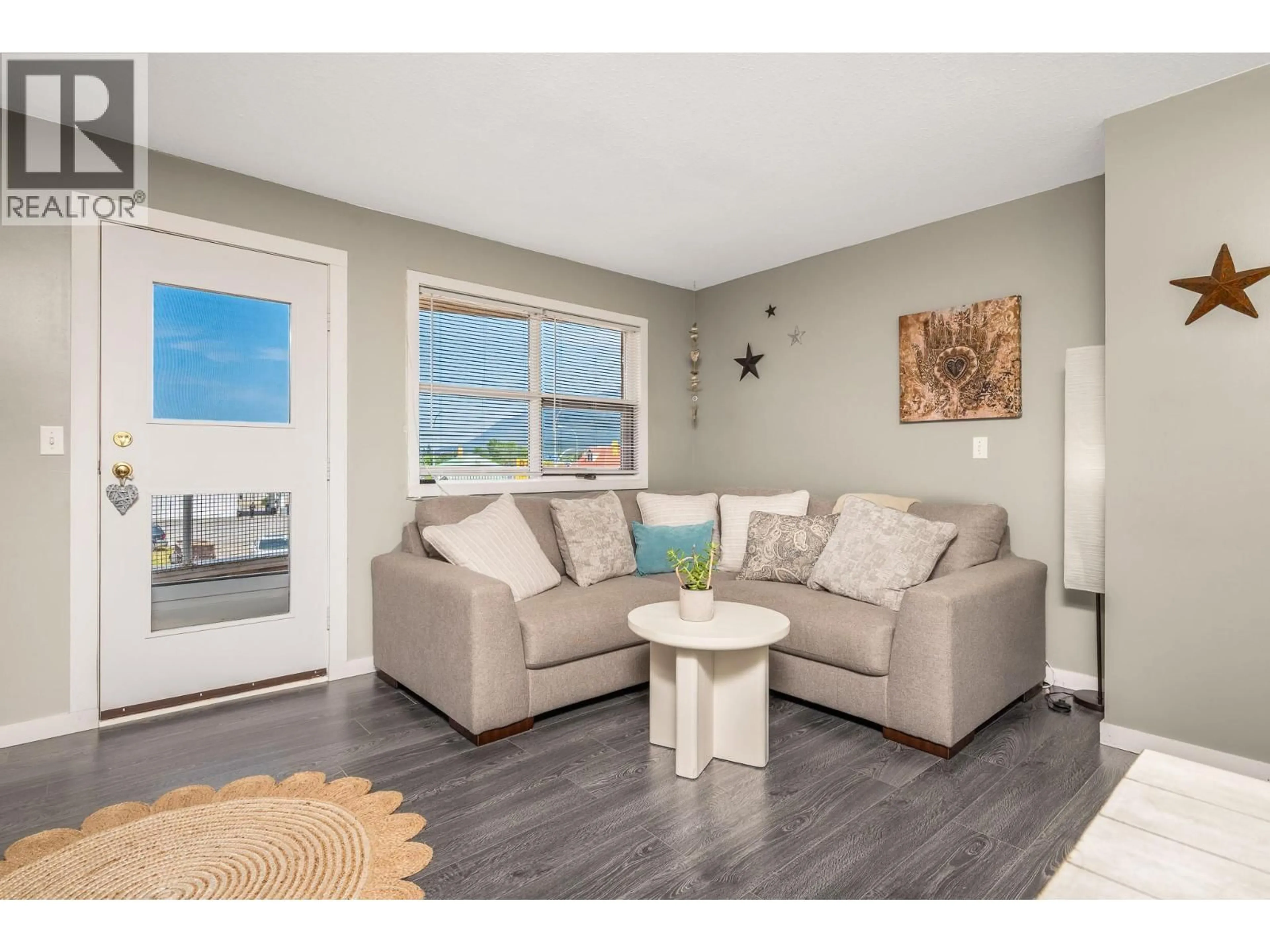 Living room with furniture, wood/laminate floor for 205 - 703 GRANVILLE AVENUE, Enderby British Columbia V4Y6A4