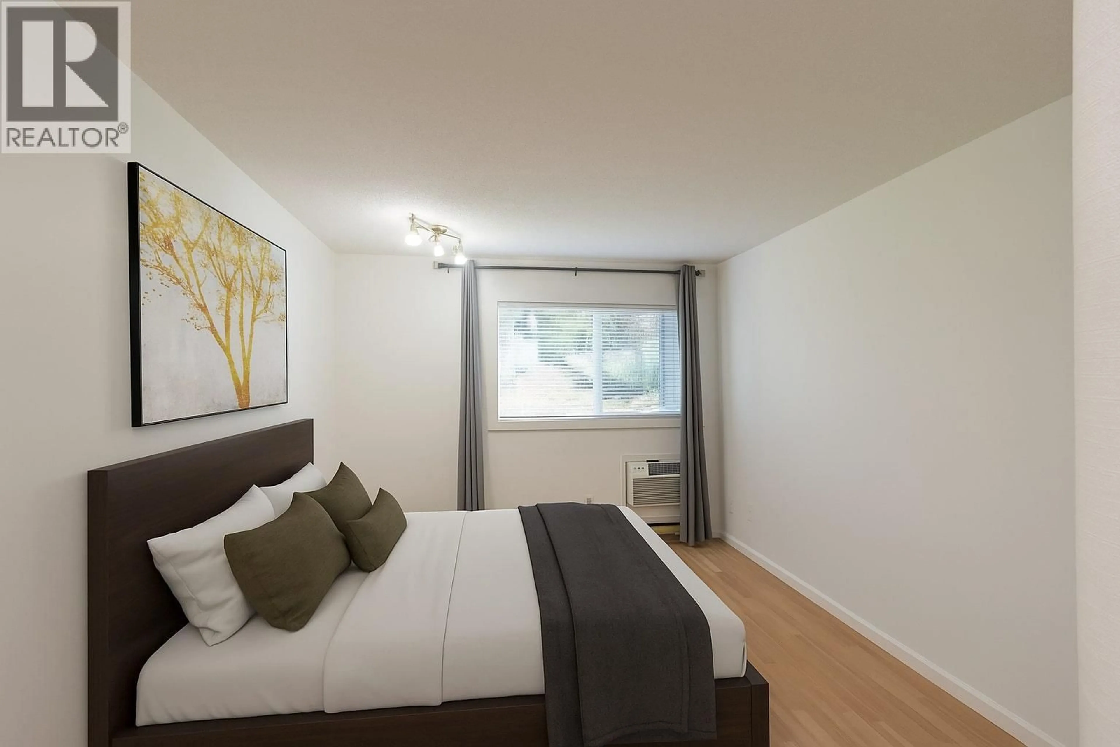 Bedroom with bed, wood/laminate floor for 106 - 445 ALL STAR COURT, Kelowna British Columbia V1X5N7