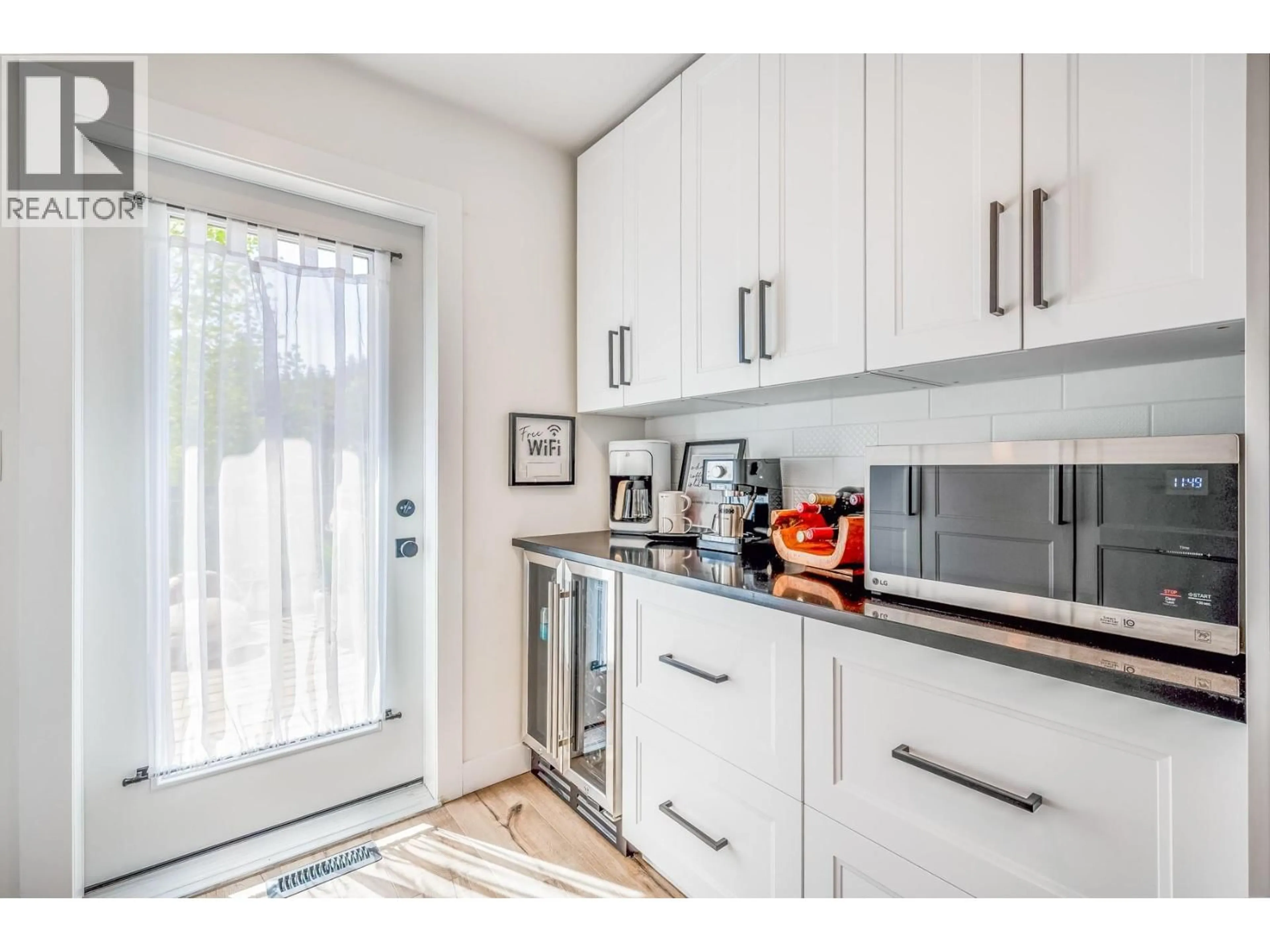 Open concept kitchen, wood/laminate floor for 1141 LYNDEN ROAD, West Kelowna British Columbia V1Z3L7