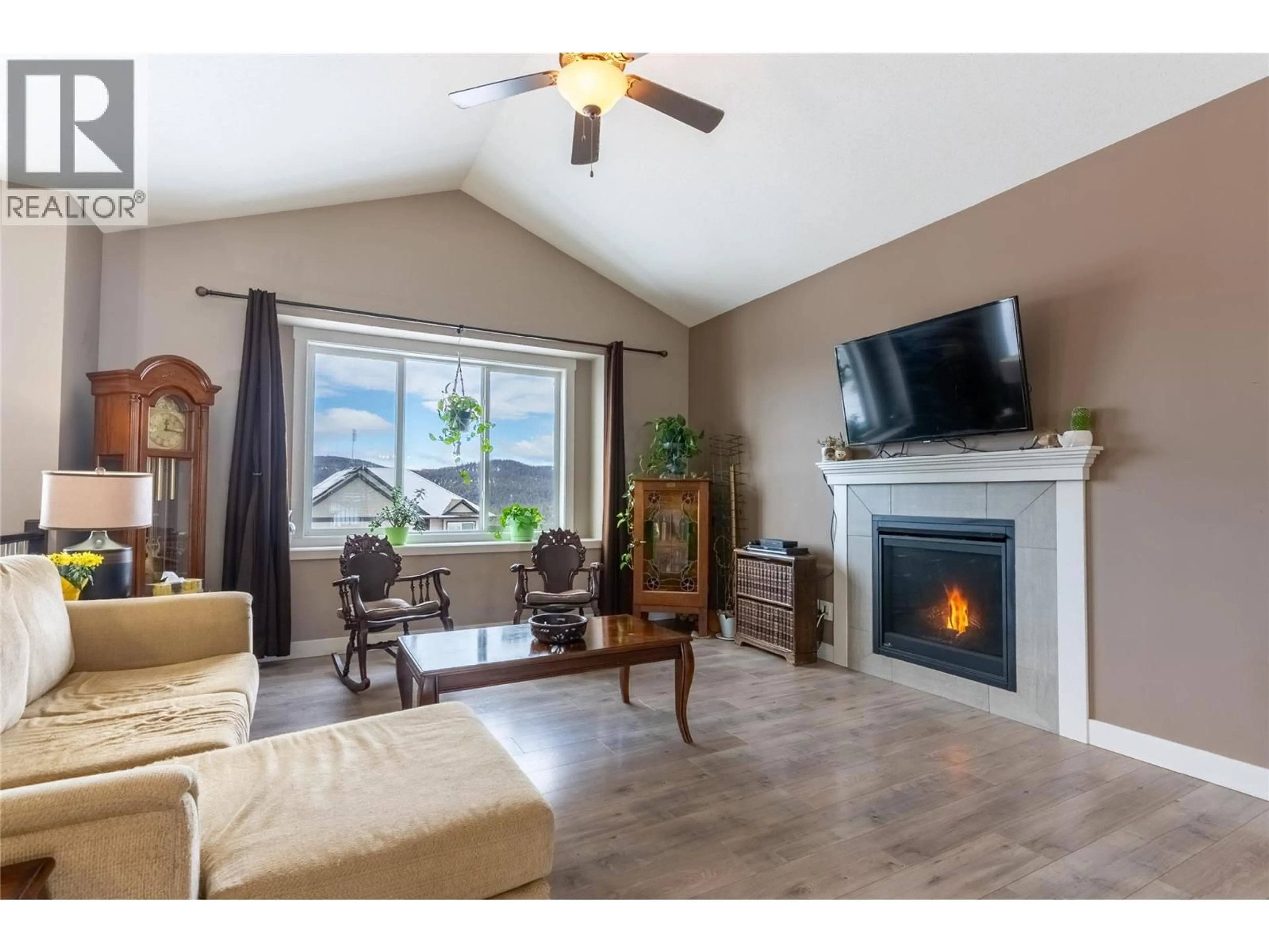 Living room with furniture, wood/laminate floor for 425 ARALIA PLACE, Logan Lake British Columbia V0K1W0