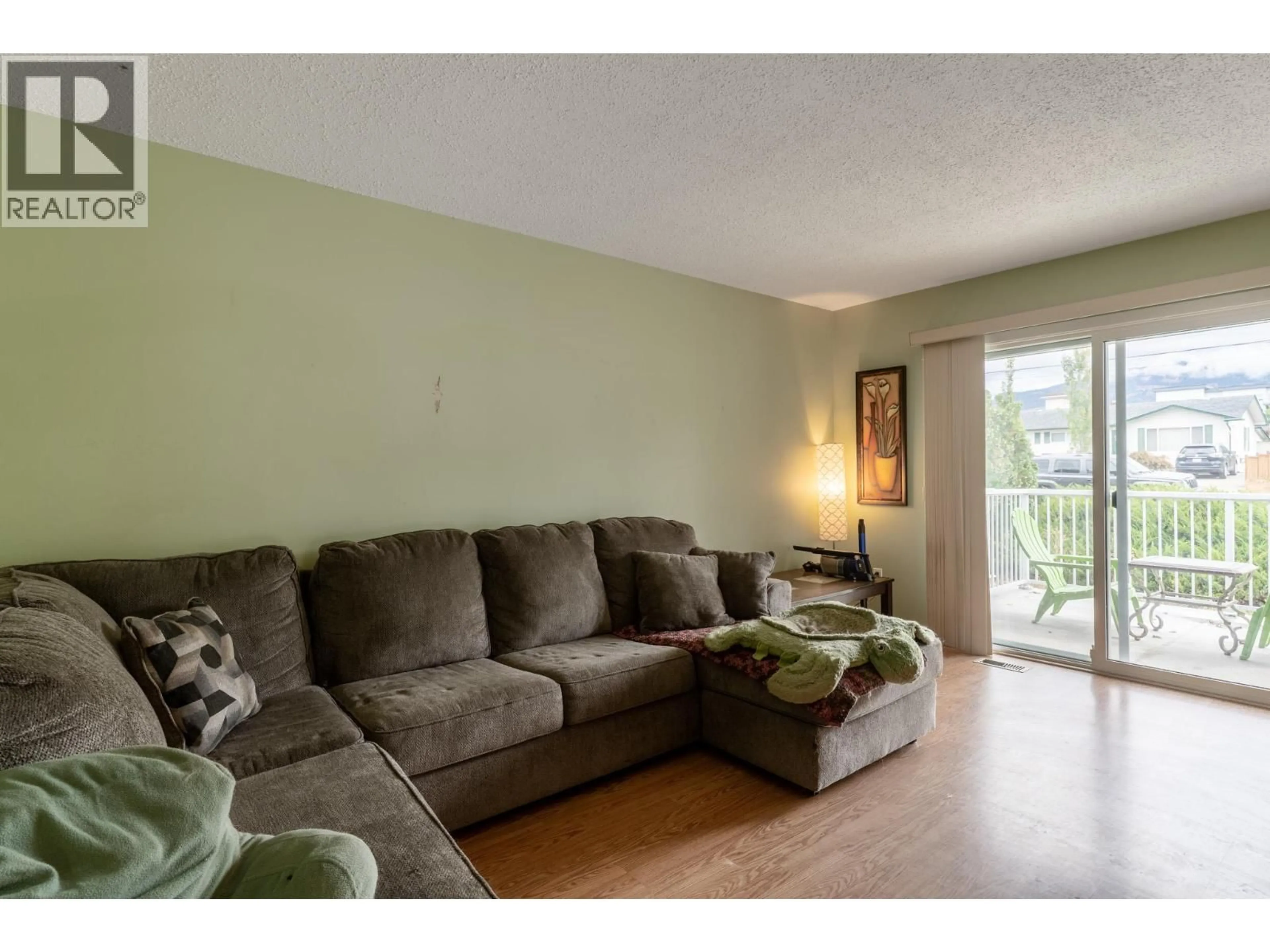 Living room with furniture, wood/laminate floor for 192 BARBER ROAD, Kelowna British Columbia V1X3V4