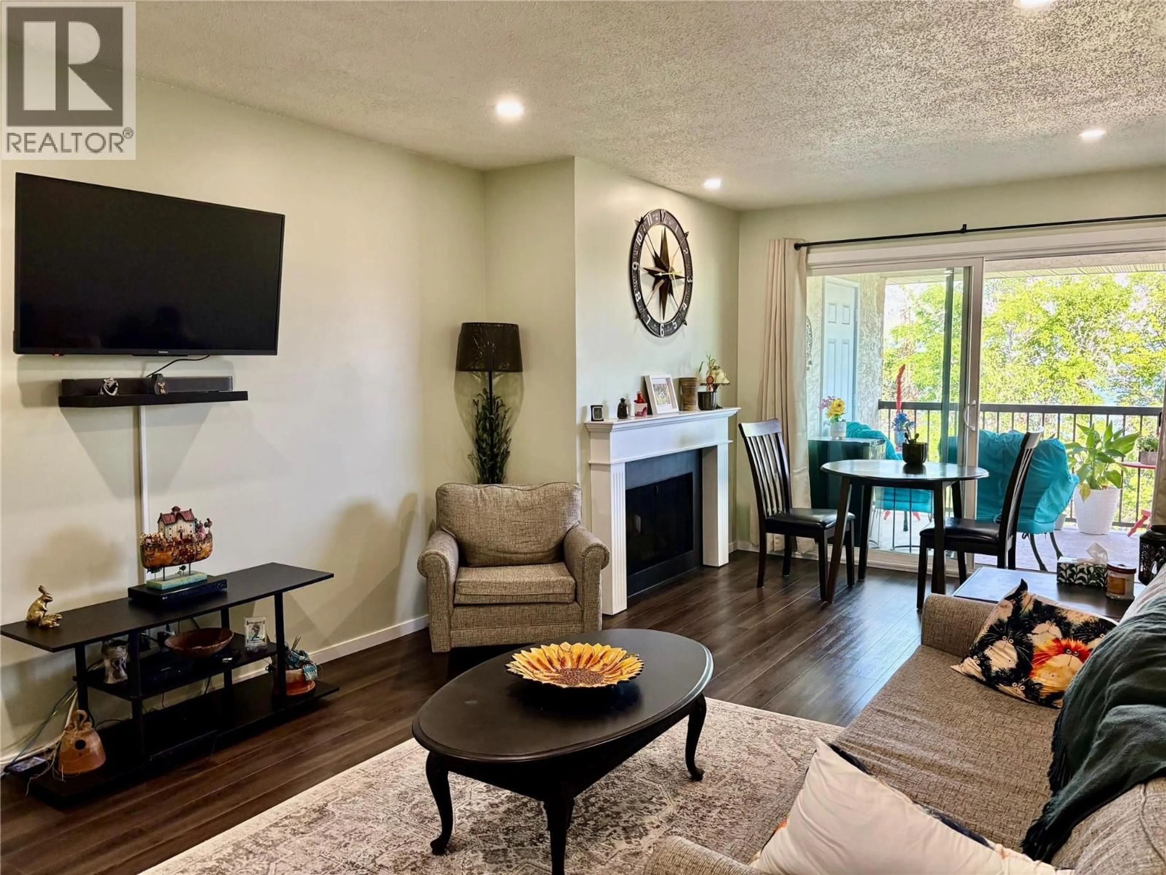 Living room with furniture, wood/laminate floor for 24 - 9107 62ND AVENUE, Osoyoos British Columbia V0H1V0
