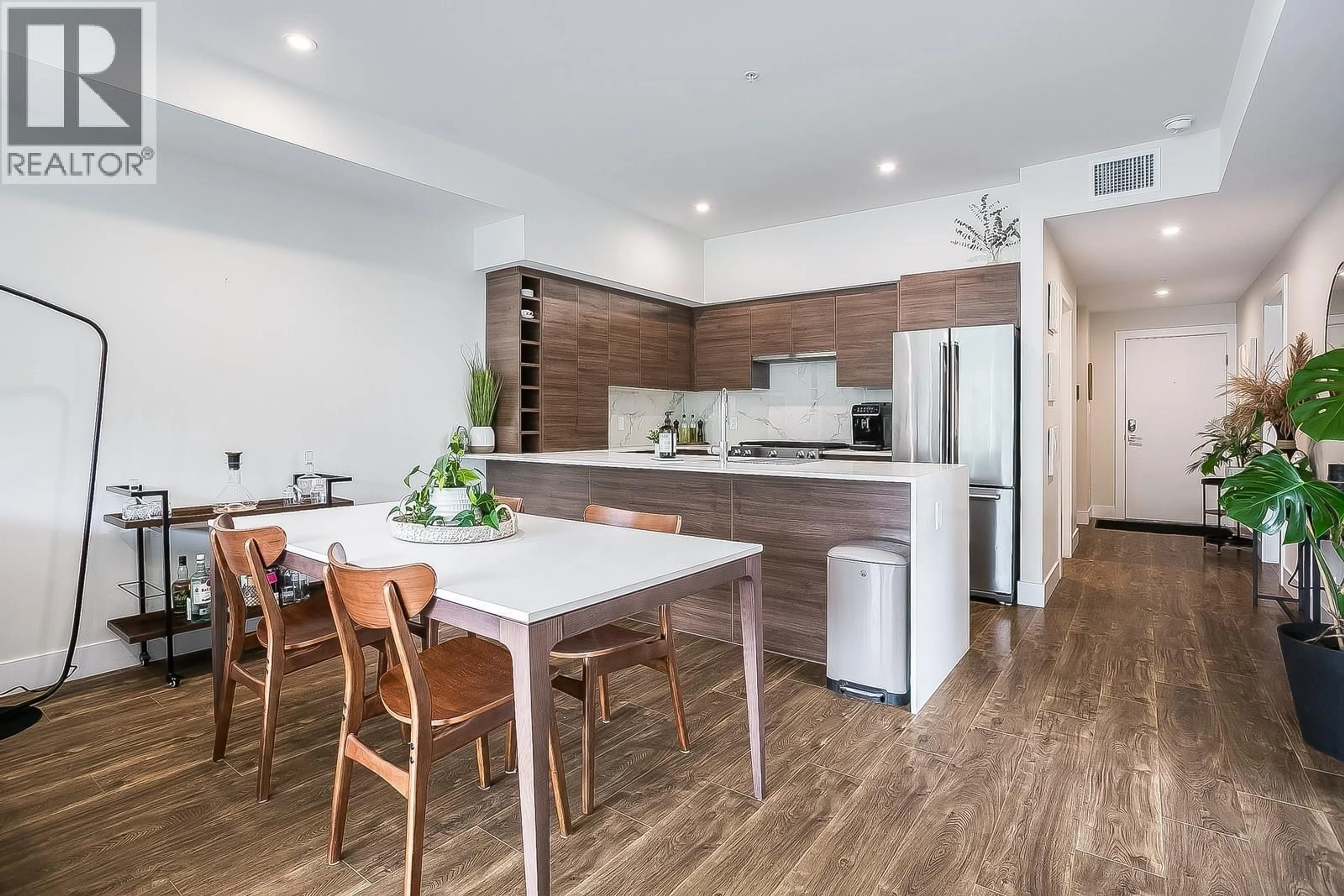 Open concept kitchen, wood/laminate floor for 402 - 1925 ENTERPRISE WAY, Kelowna British Columbia V1Y0J8