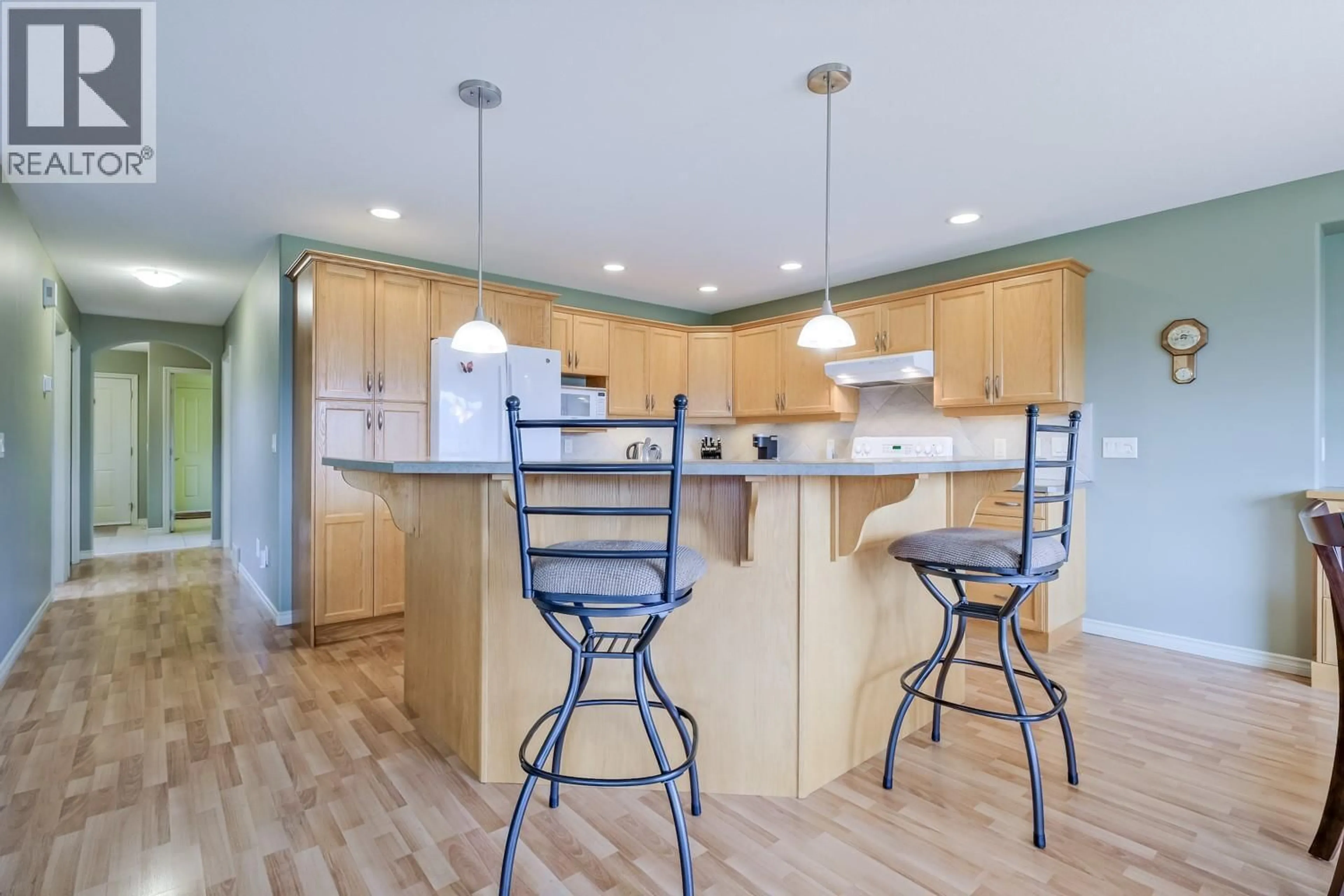 Open concept kitchen, wood/laminate floor for 111 - 2365 STILLINGFLEET ROAD, Kelowna British Columbia V1W4X5