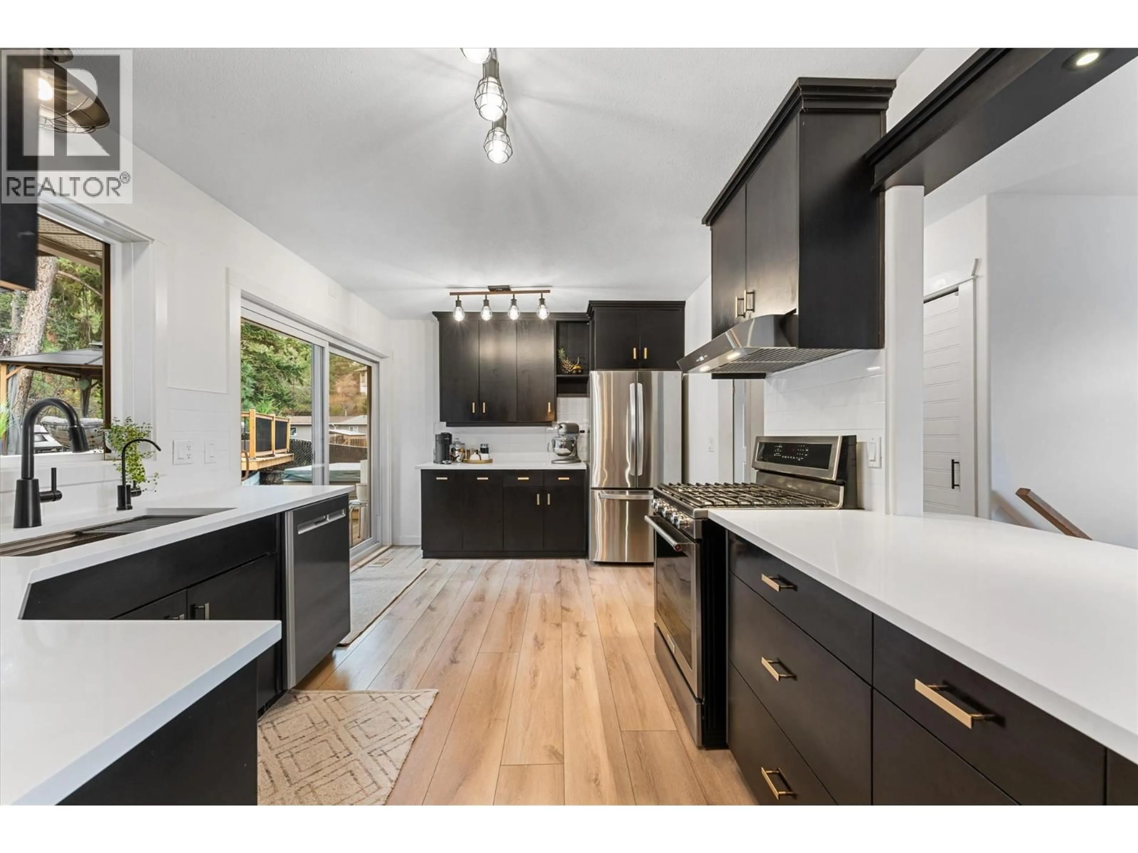 Open concept kitchen, wood/laminate floor for 3380 MCIVER ROAD, West Kelowna British Columbia V4T1H7