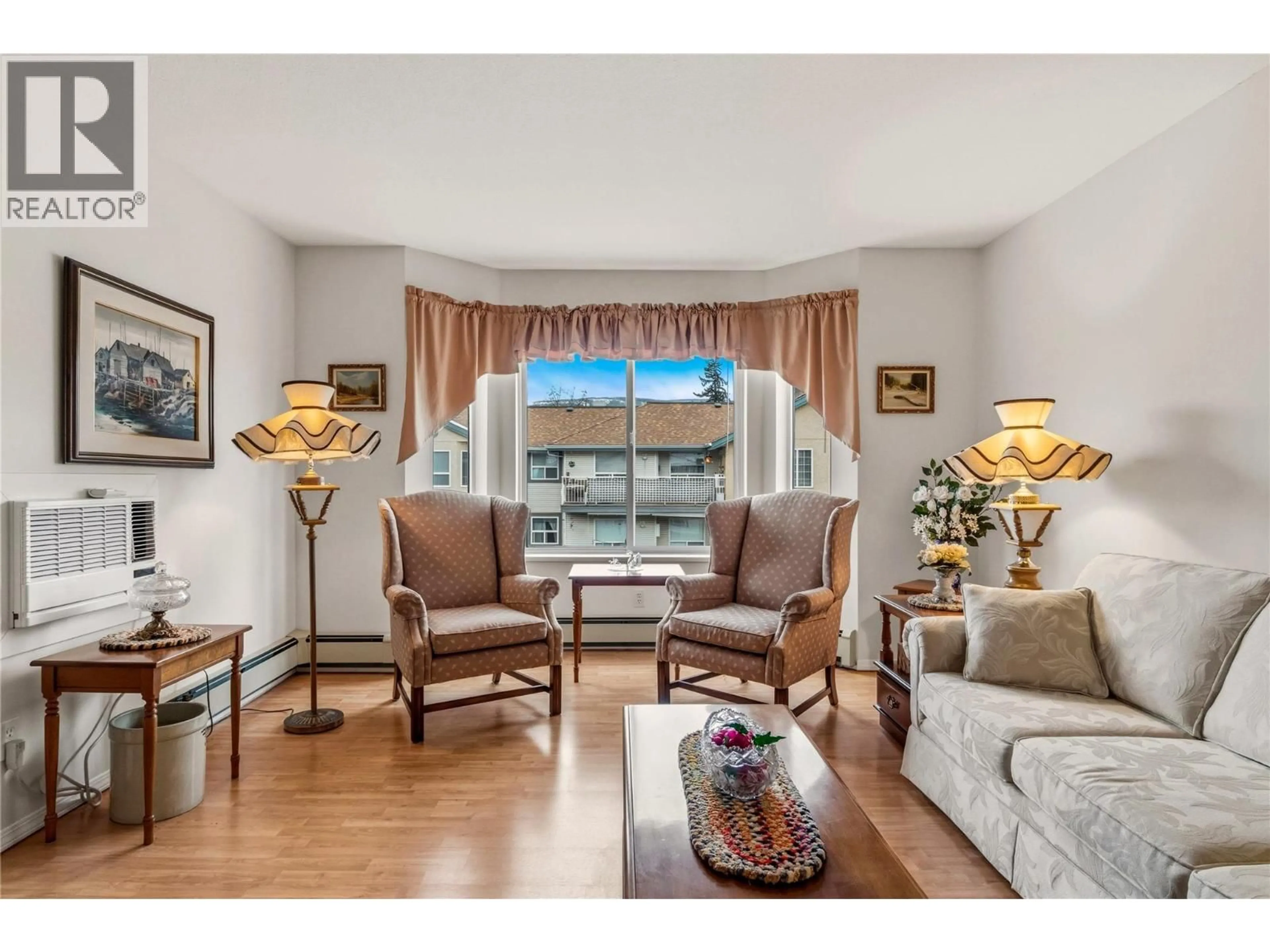 Living room with furniture, wood/laminate floor for 306 - 251 6 STREET SOUTHEAST, Salmon Arm British Columbia V1E1J9