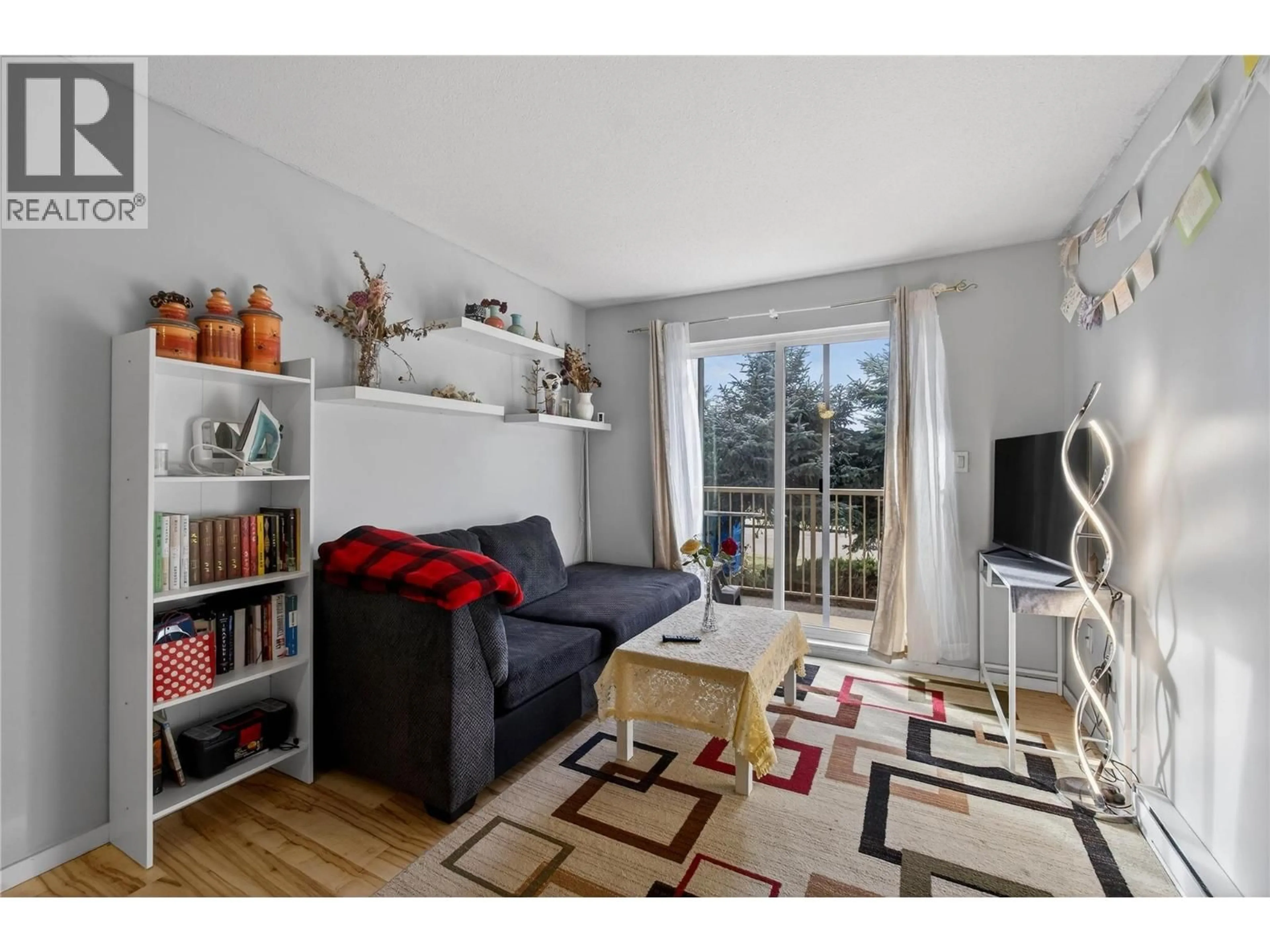 Living room with furniture, wood/laminate floor for 215 - 3304 35TH AVENUE, Vernon British Columbia V1T8M6