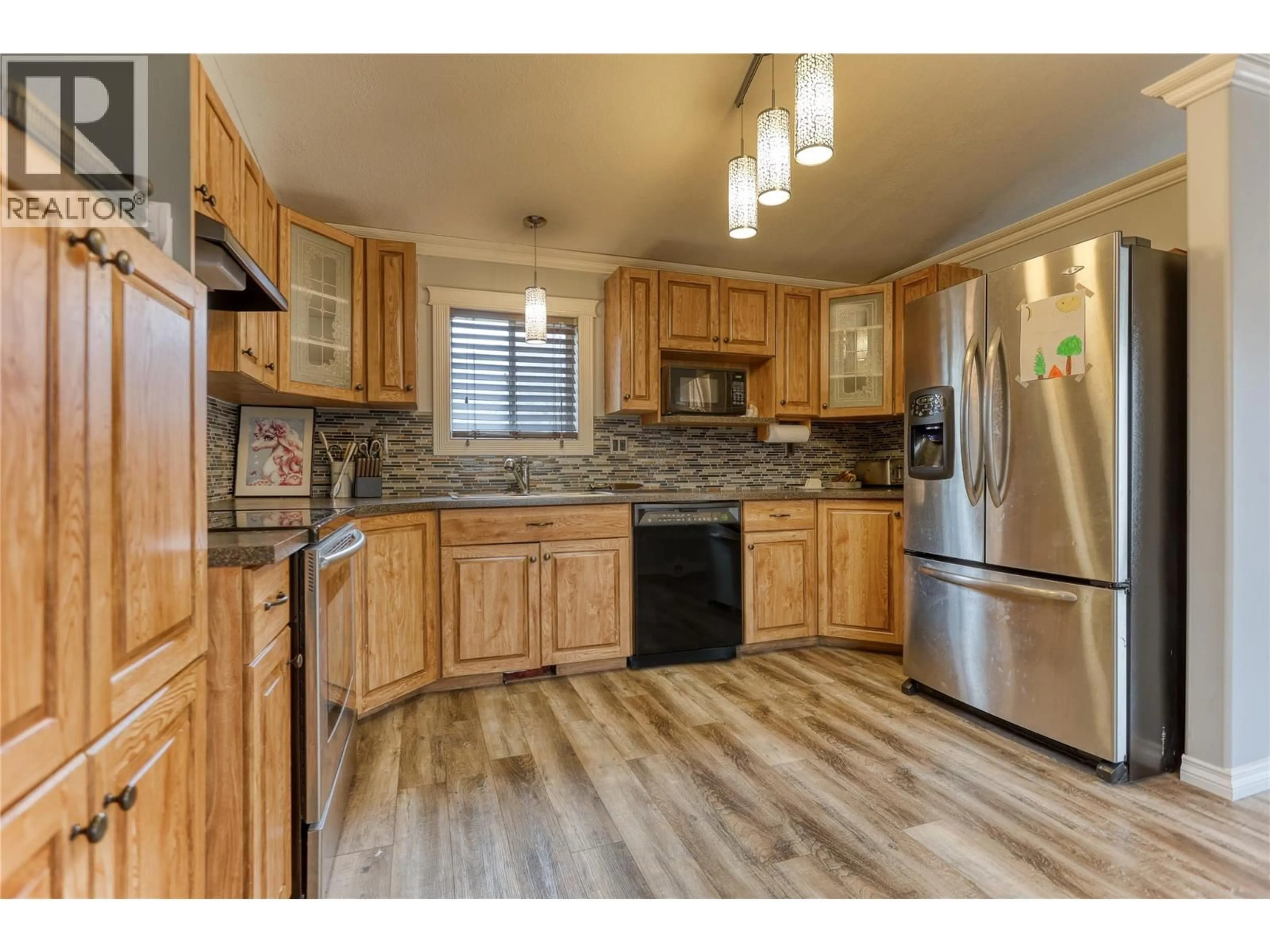 Open concept kitchen, wood/laminate floor for 6450 7TH STREET, Grand Forks British Columbia V0H1H4
