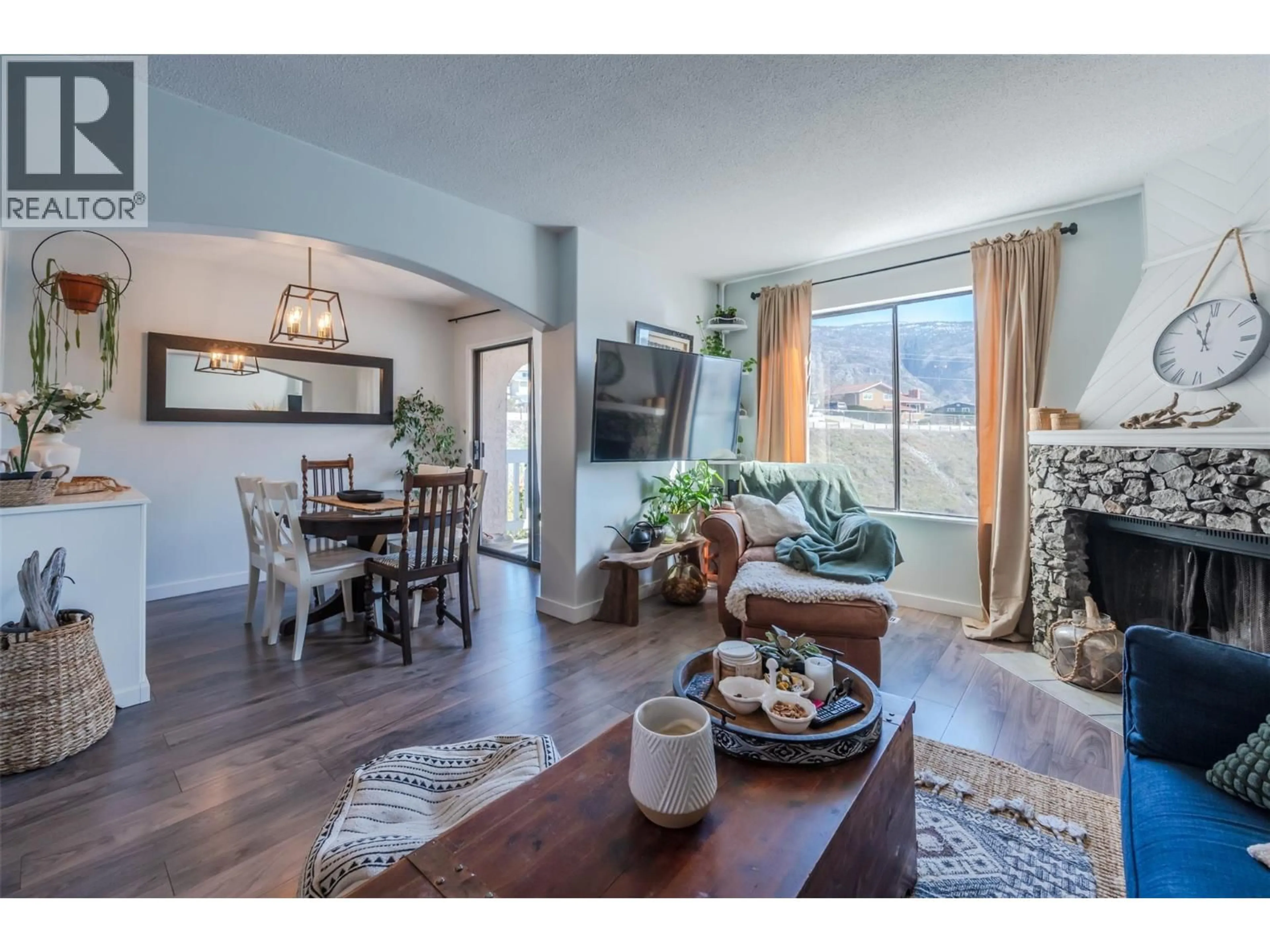 Living room with furniture, wood/laminate floor for 1A - 8043 VEDETTE DRIVE, Osoyoos British Columbia V0H1V2
