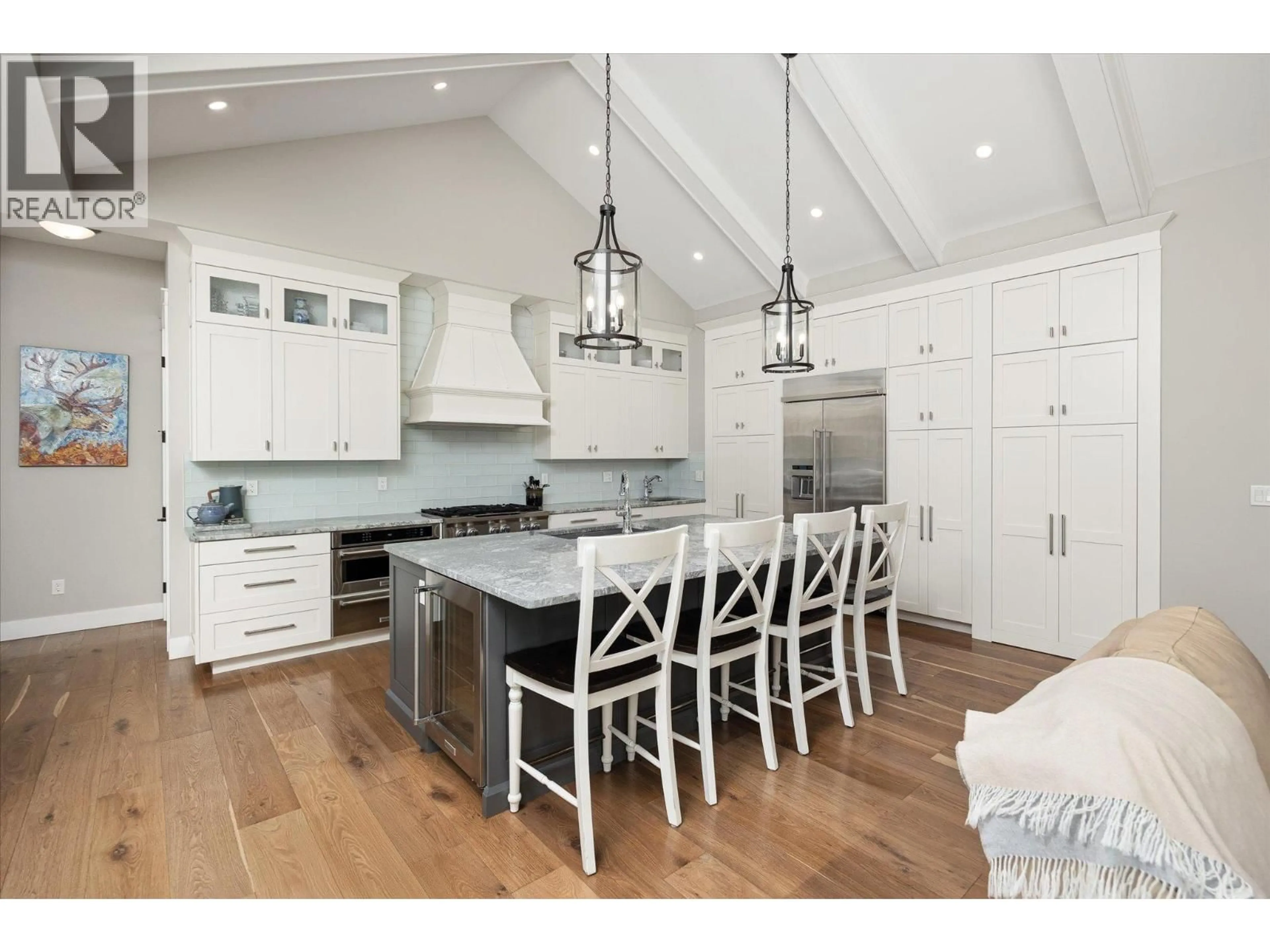 Open concept kitchen, wood/laminate floor for 7844 CHEW ROAD, Vernon British Columbia V1B3N6