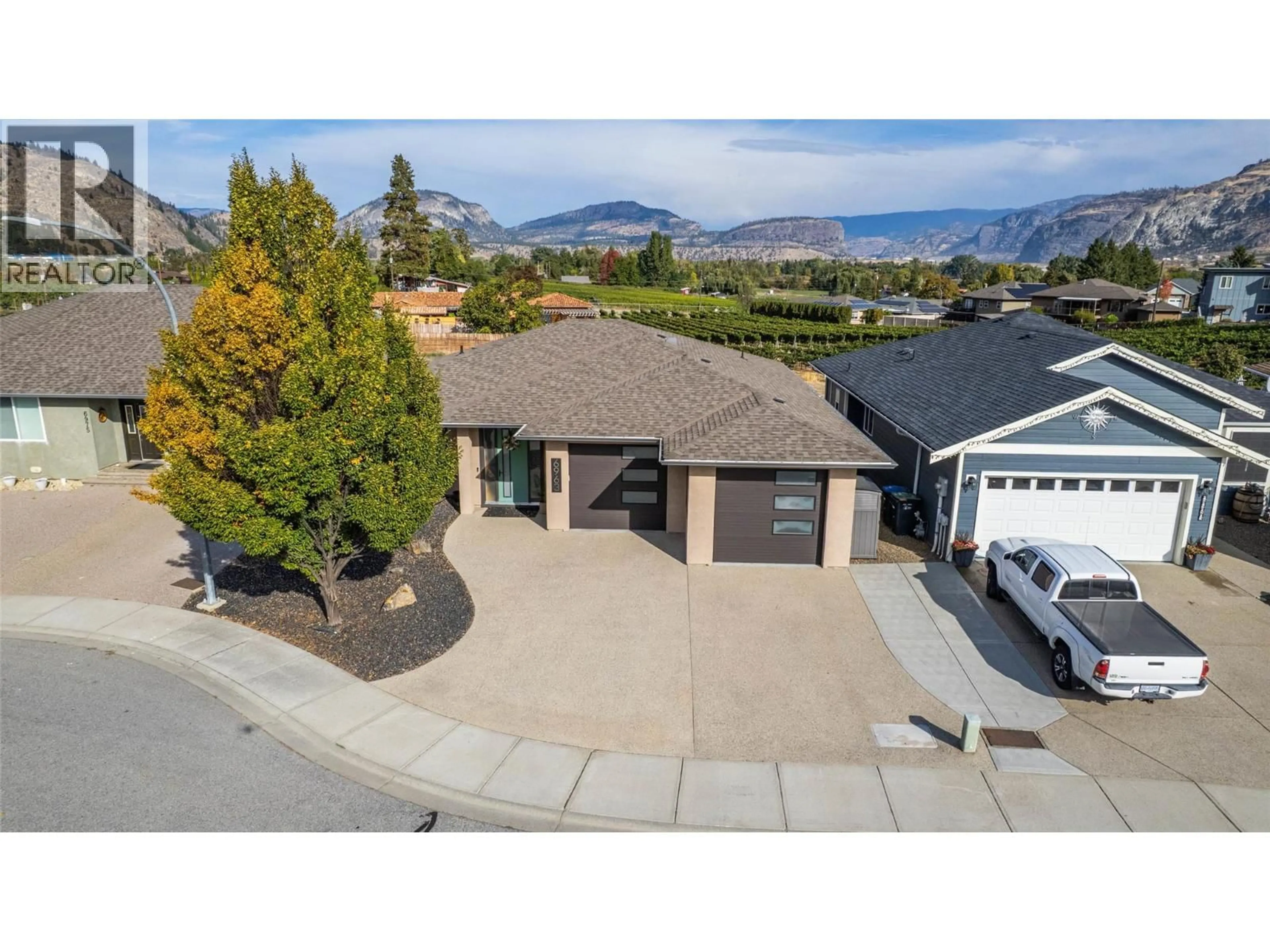 A pic from outside/outdoor area/front of a property/back of a property/a pic from drone, mountain view for 6963 CHARDONNAY PLACE, Oliver British Columbia V0H1T4