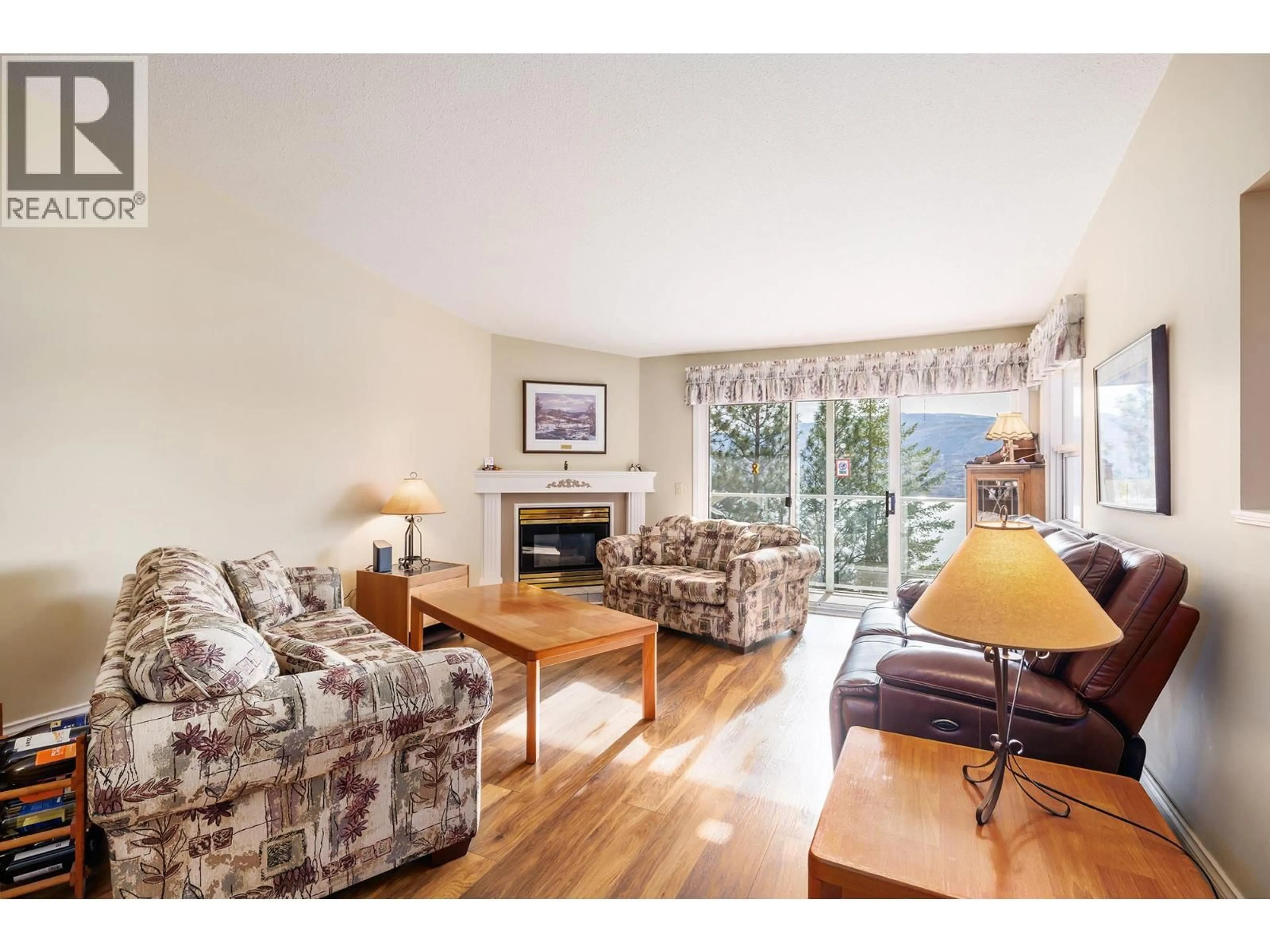 Living room with furniture, wood/laminate floor for 202 - 4450 PONDEROSA DRIVE, Peachland British Columbia V0H1X5