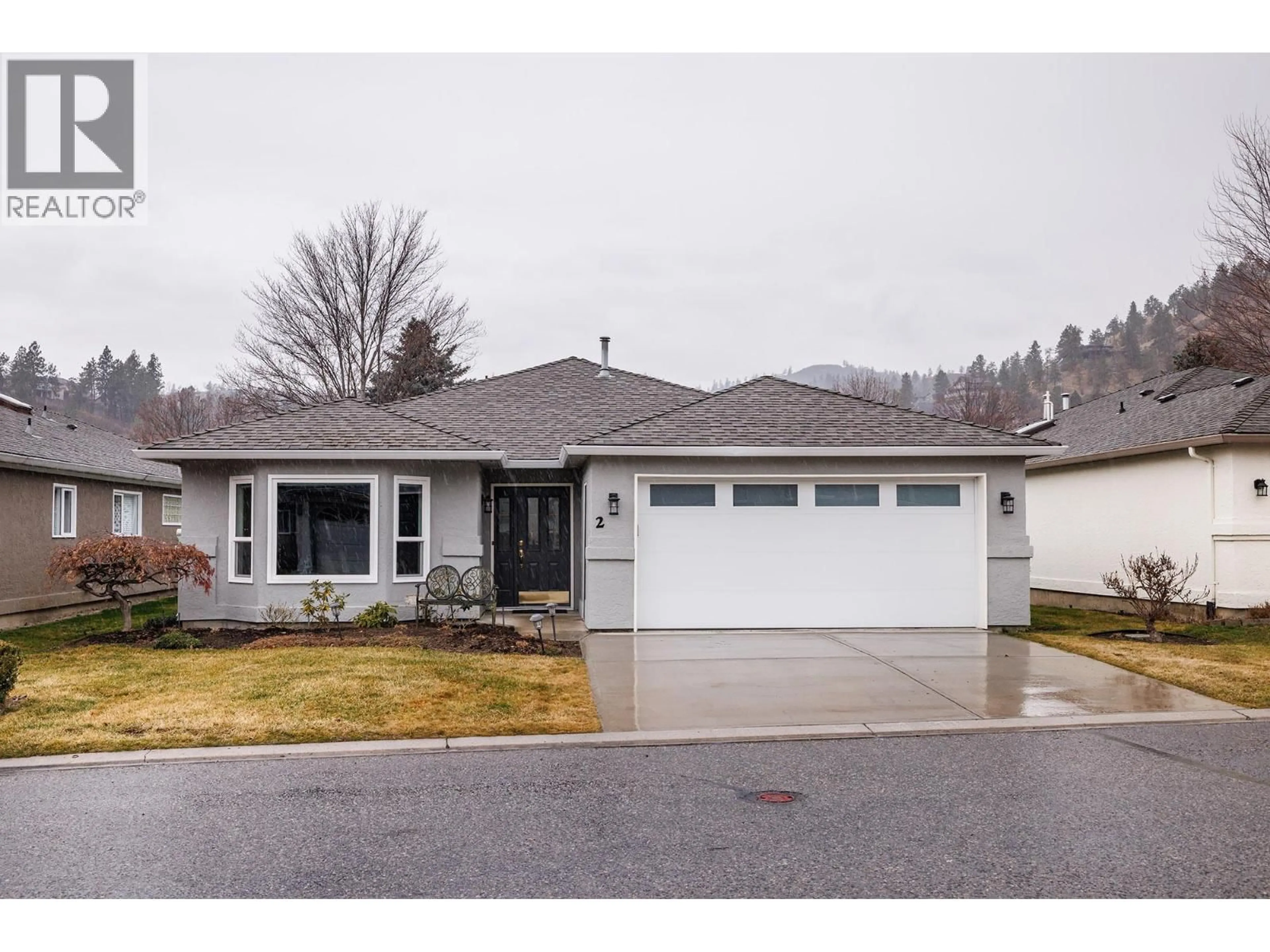 Home with vinyl exterior material, street for 2 - 615 GLENMEADOWS ROAD, Kelowna British Columbia V1V1N9