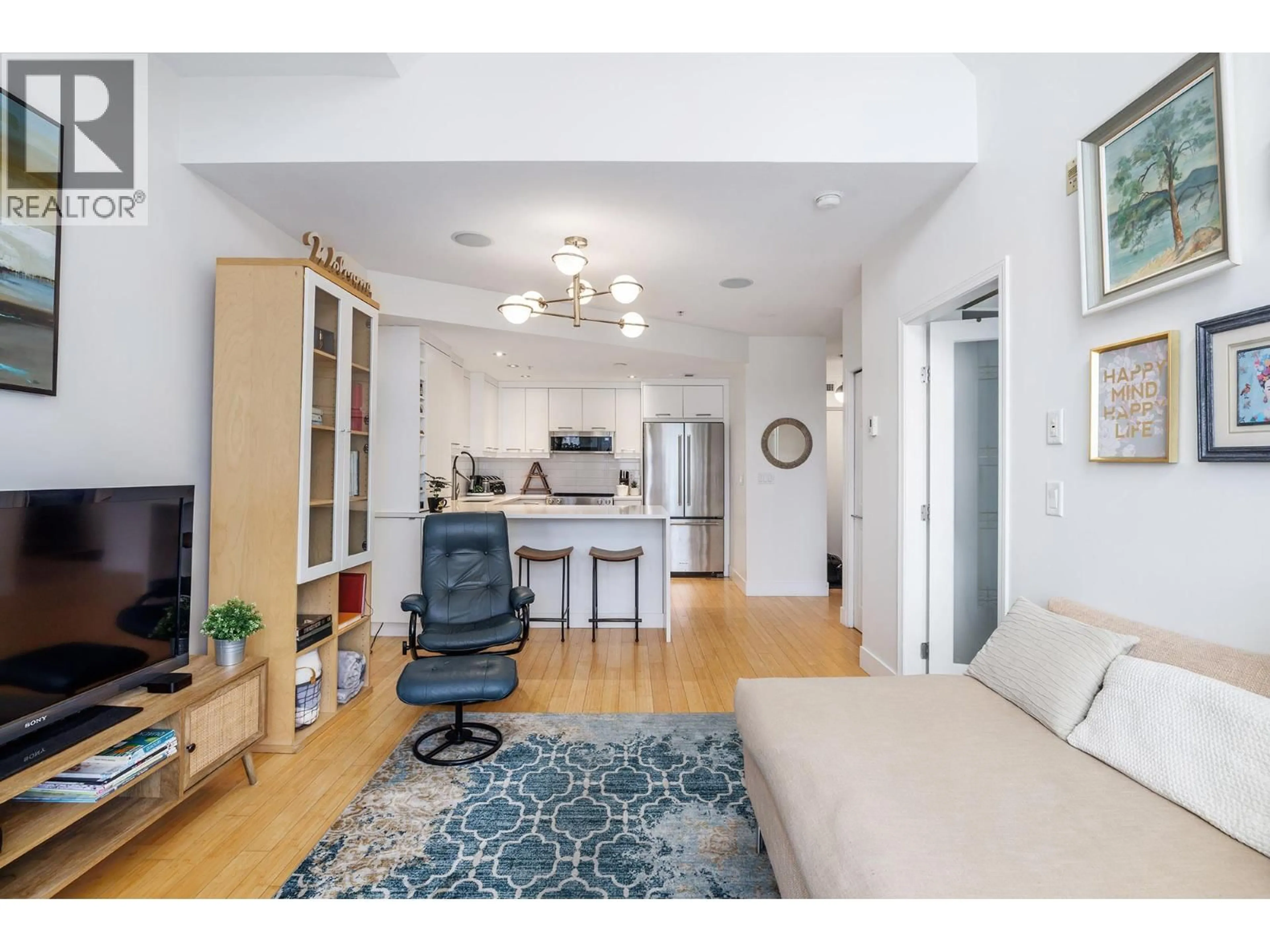 Living room with furniture, wood/laminate floor for 247 - 1088 SUNSET DRIVE, Kelowna British Columbia V1Y9W1