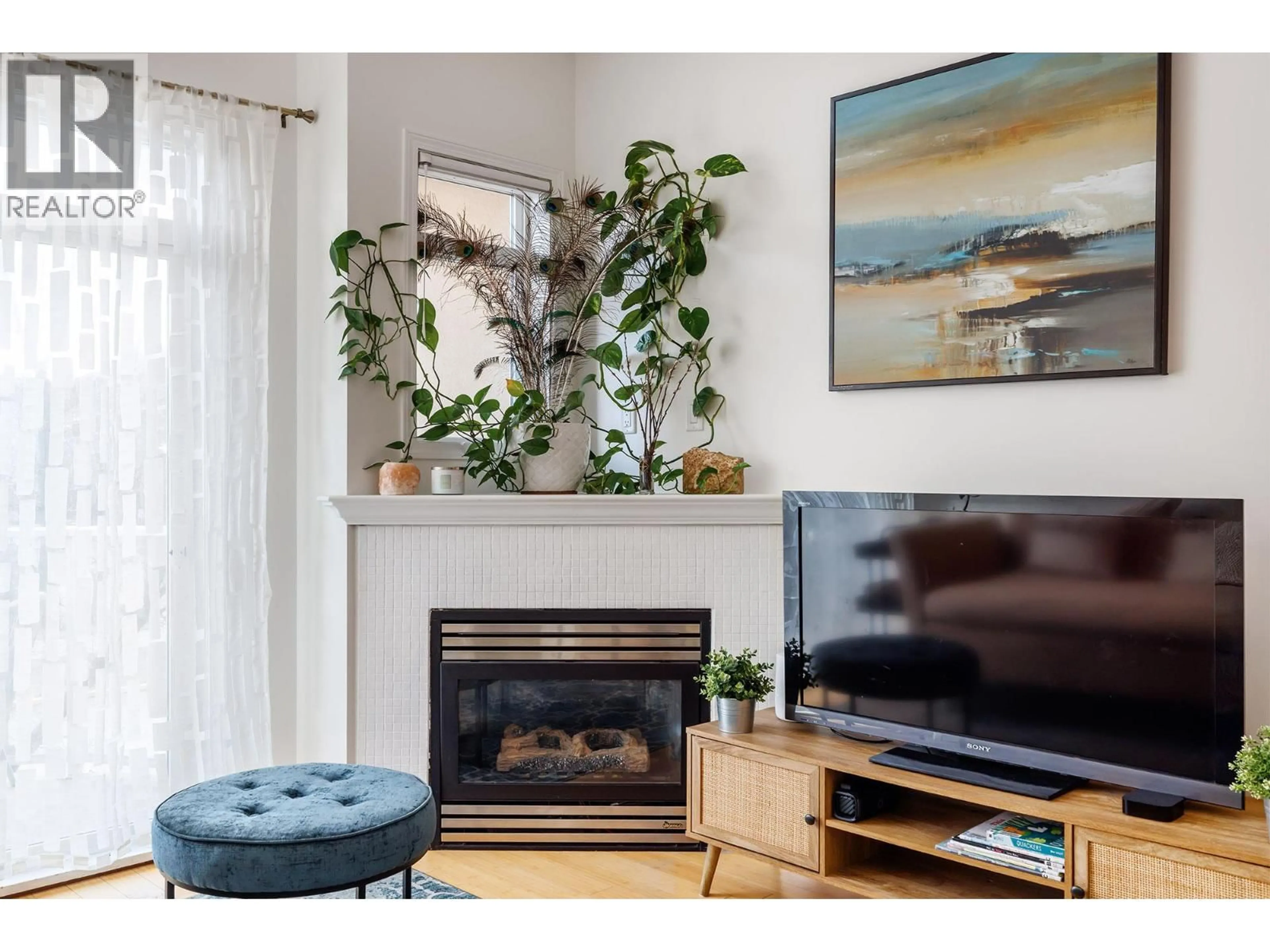 Living room with furniture, wood/laminate floor for 247 - 1088 SUNSET DRIVE, Kelowna British Columbia V1Y9W1