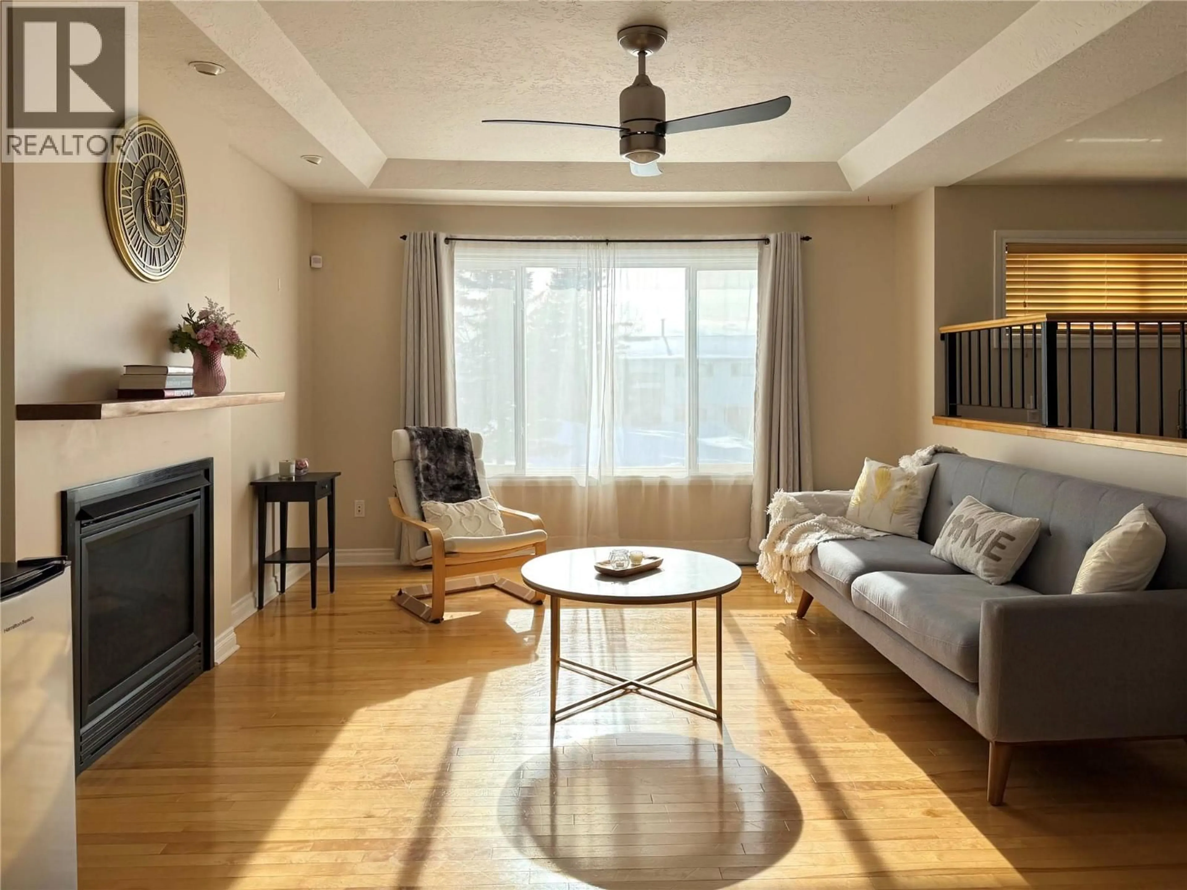 Living room with furniture, wood/laminate floor for 1816 89 AVENUE, Dawson Creek British Columbia V1G5A7