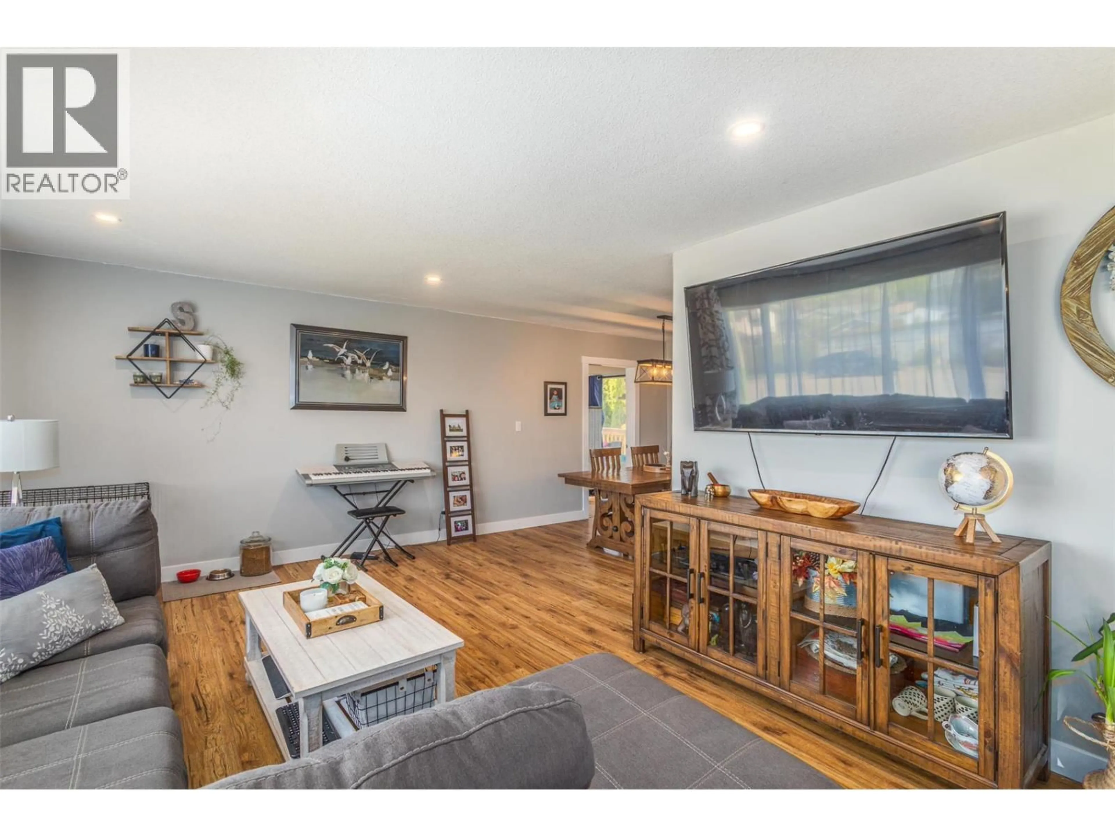Living room with furniture, wood/laminate floor for 3339 BOTHE ROAD, Kelowna British Columbia V1W3M3