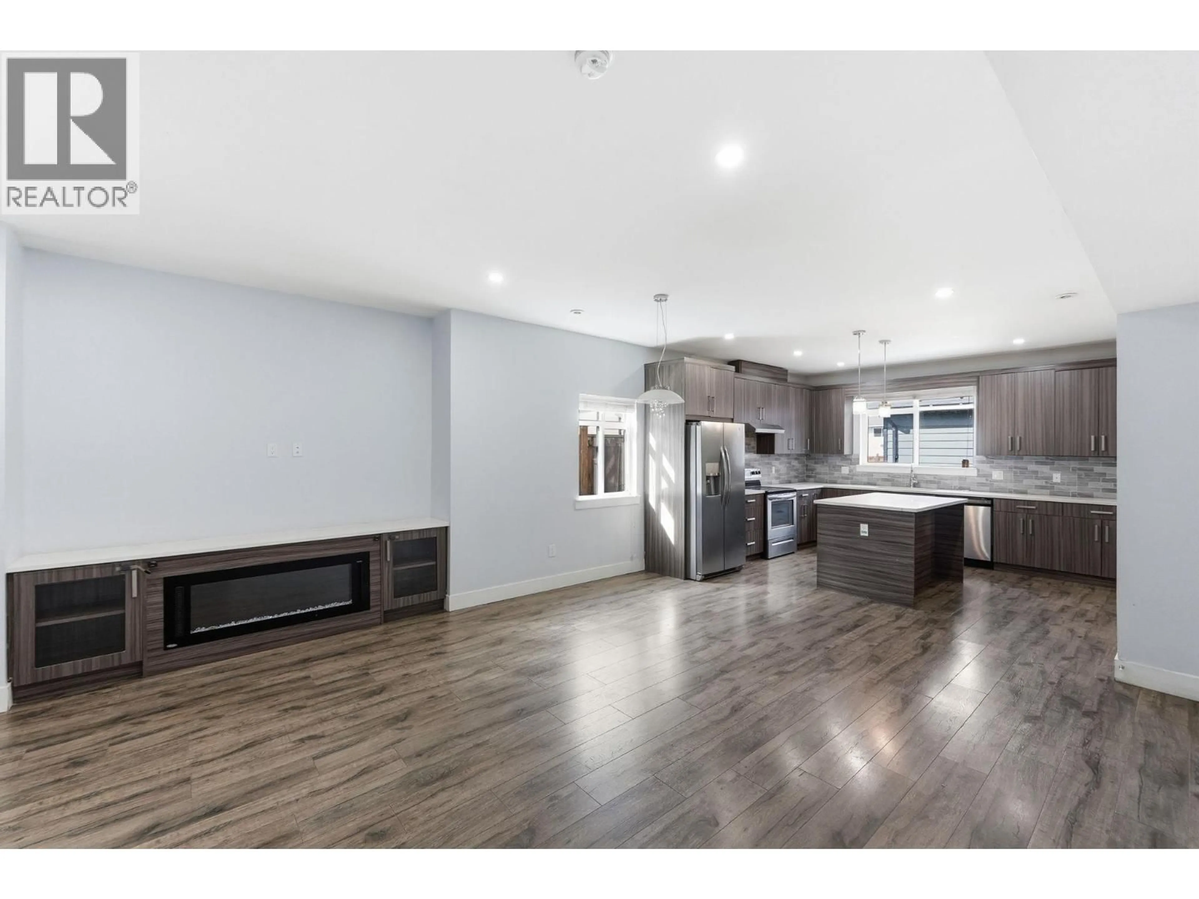 Open concept kitchen, wood/laminate floor for 1 - 722 COOPLAND CRESCENT, Kelowna British Columbia V1Y2V1