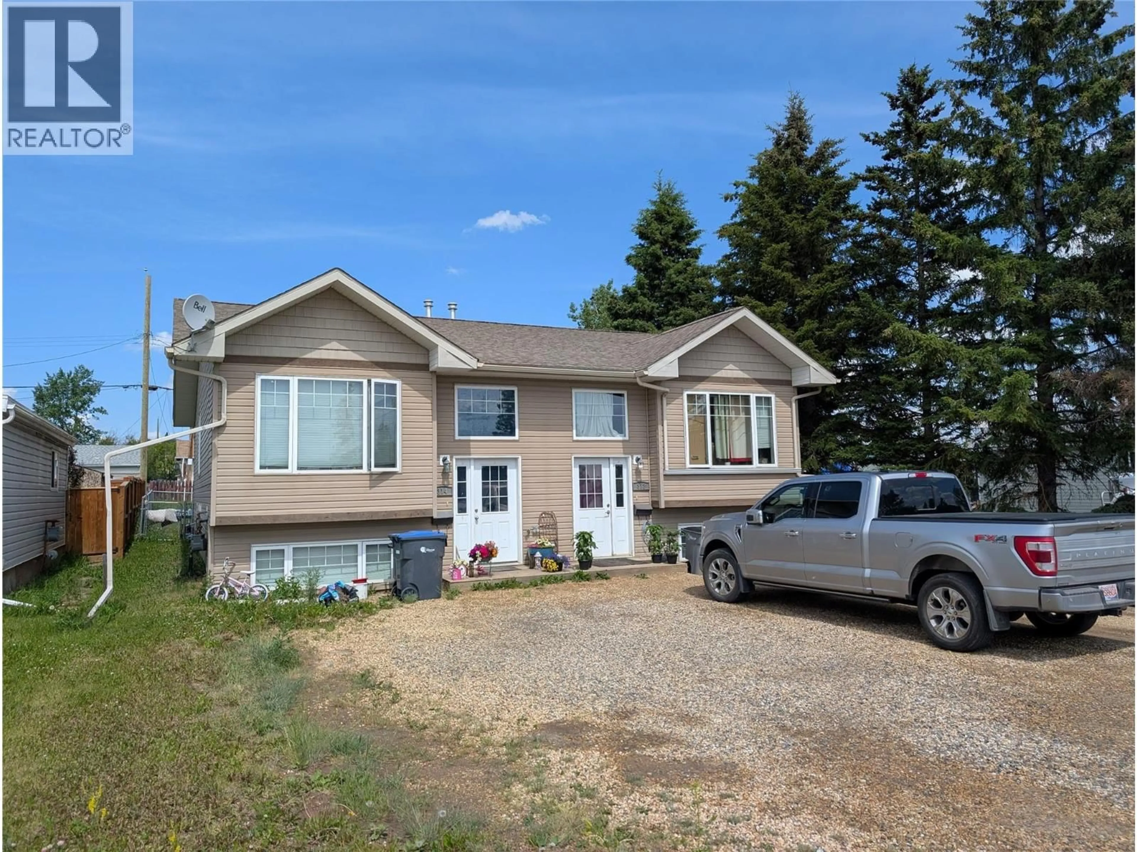 Home with vinyl exterior material, street for 312 99 AVENUE, Dawson Creek British Columbia V1G1S9