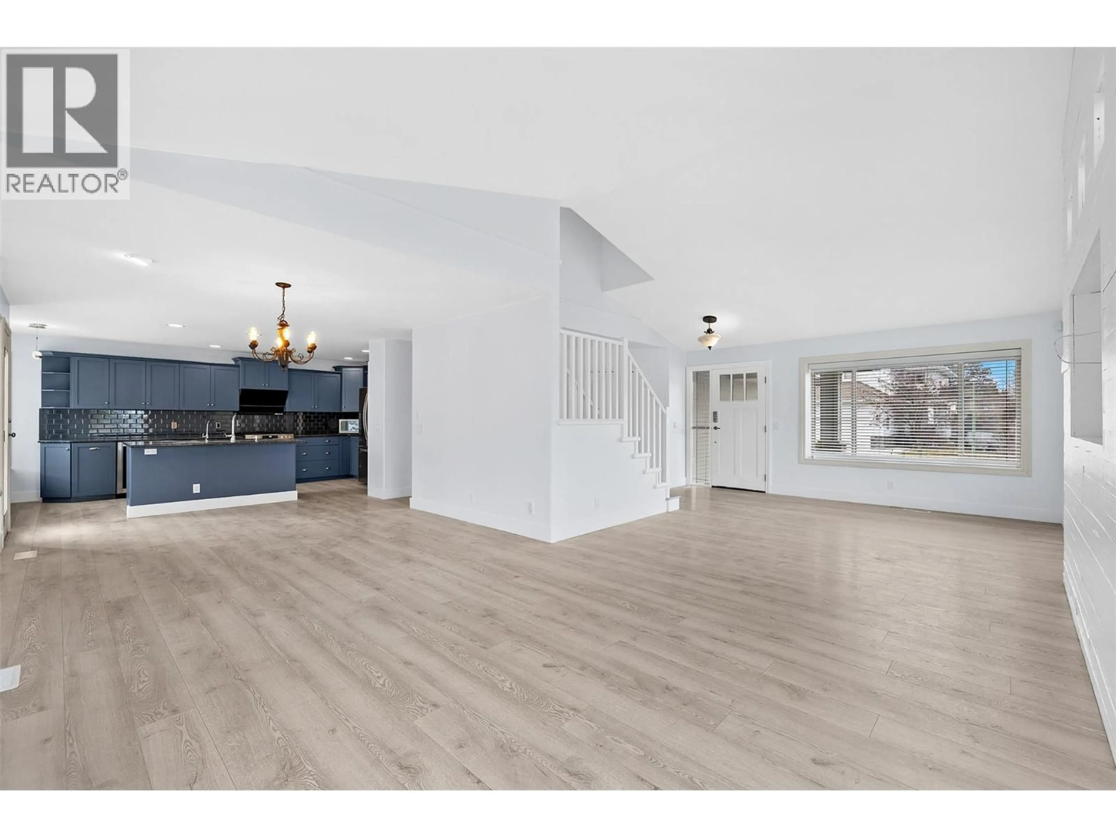 Open concept kitchen, wood/laminate floor for 5095 WINDSONG CRESCENT, Kelowna British Columbia V1W5B5