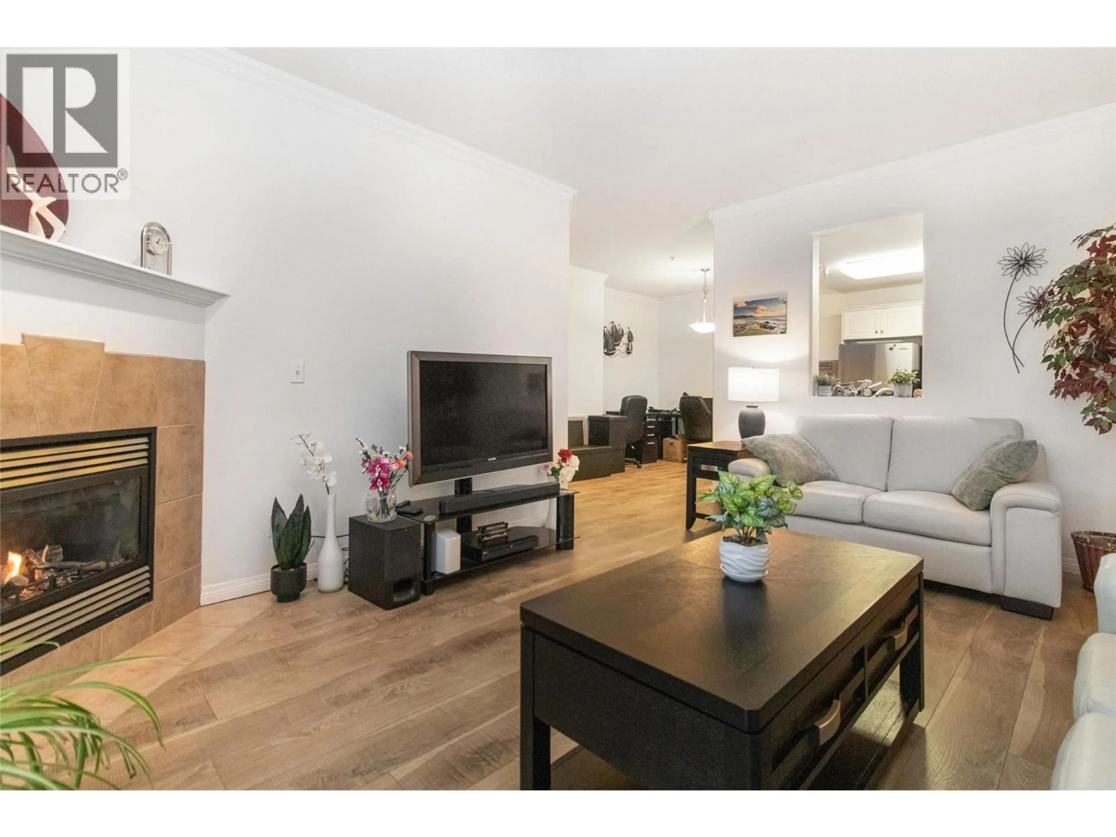 Living room with furniture, wood/laminate floor for 309 - 1960 ENTERPRISE WAY, Kelowna British Columbia V1Y9S5