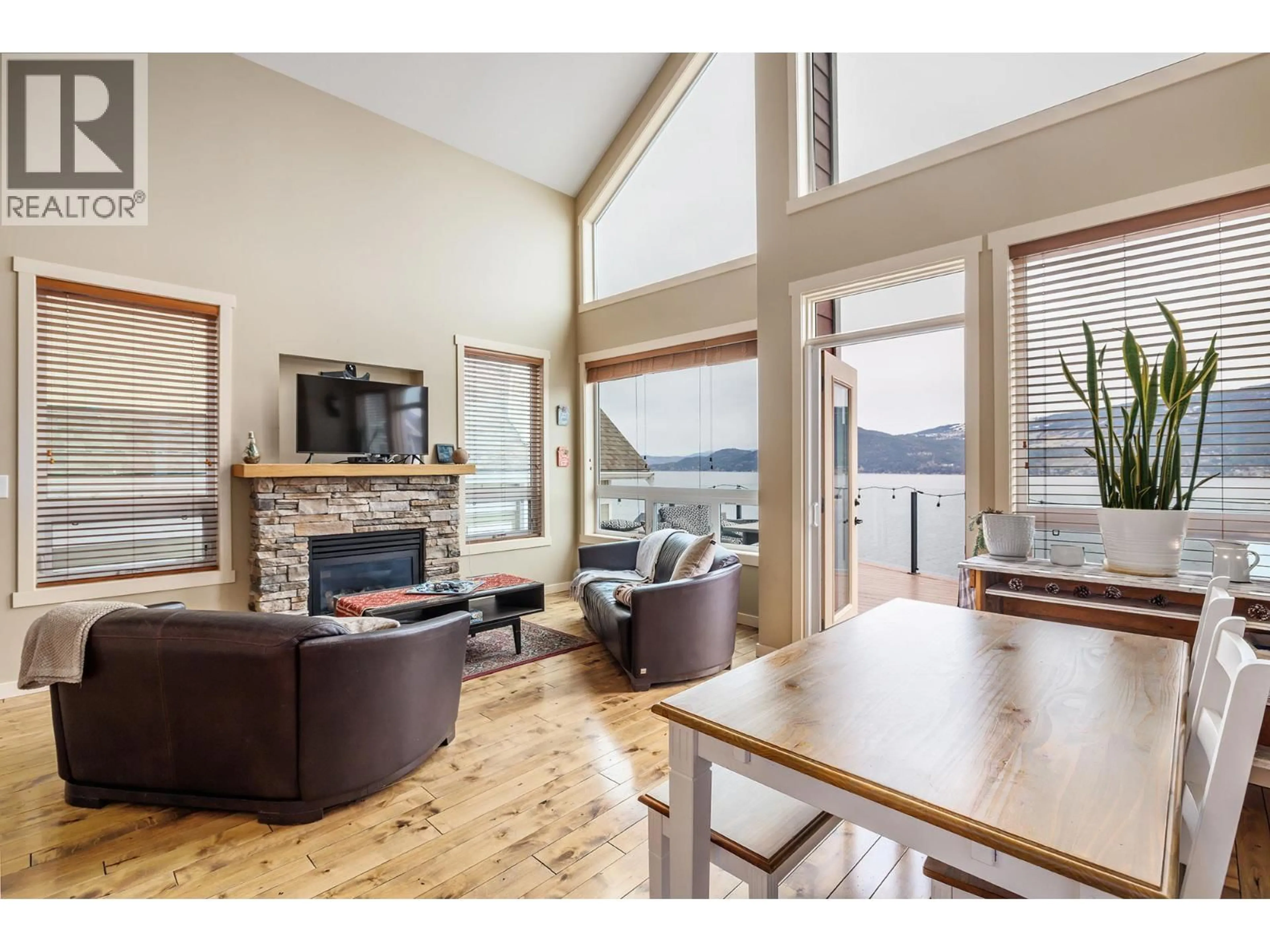 Living room with furniture, wood/laminate floor for 6930 BARCELONA DRIVE, Kelowna British Columbia V1Z3R8