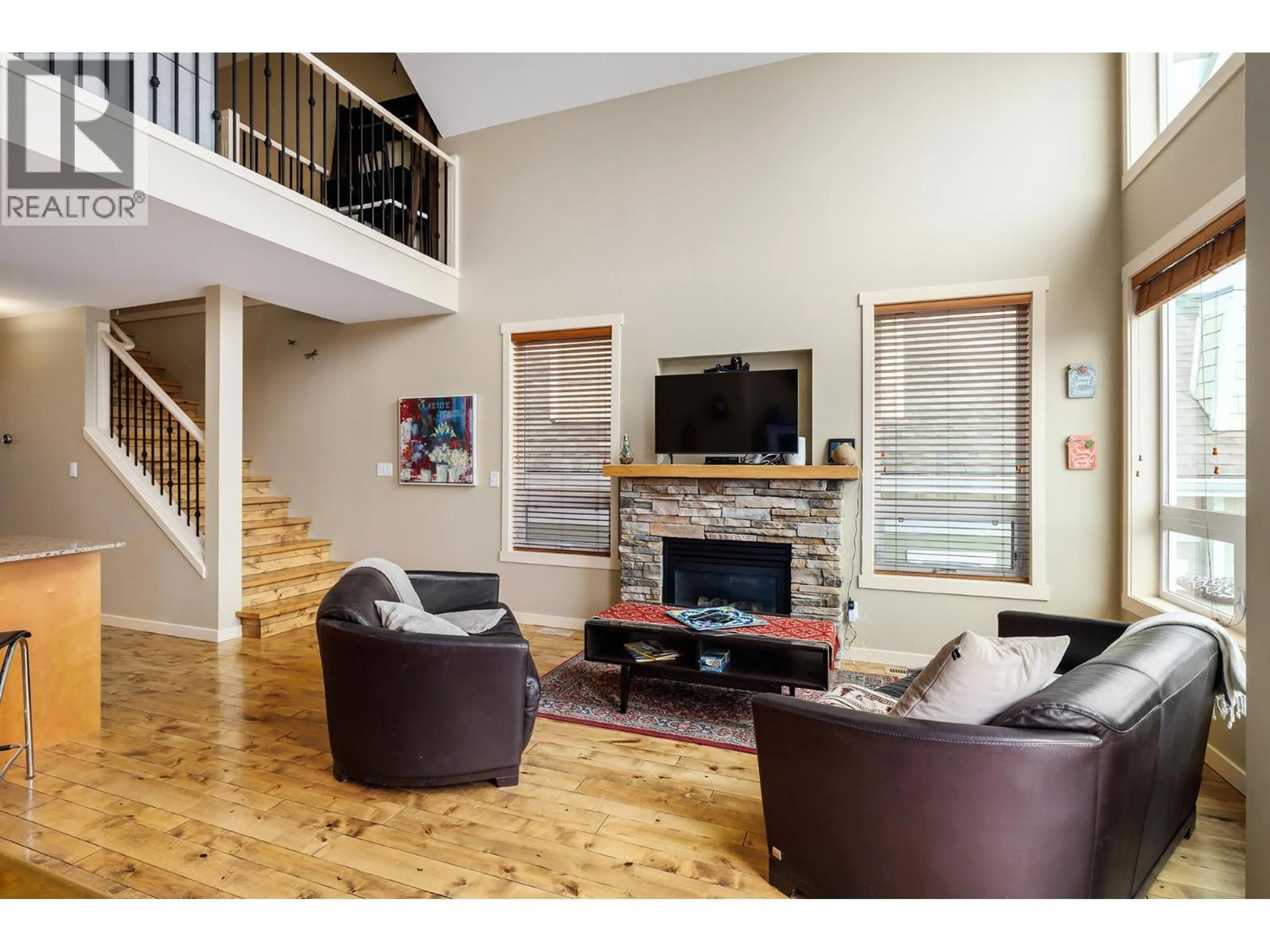 Living room with furniture, wood/laminate floor for 6930 BARCELONA DRIVE, Kelowna British Columbia V1Z3R8