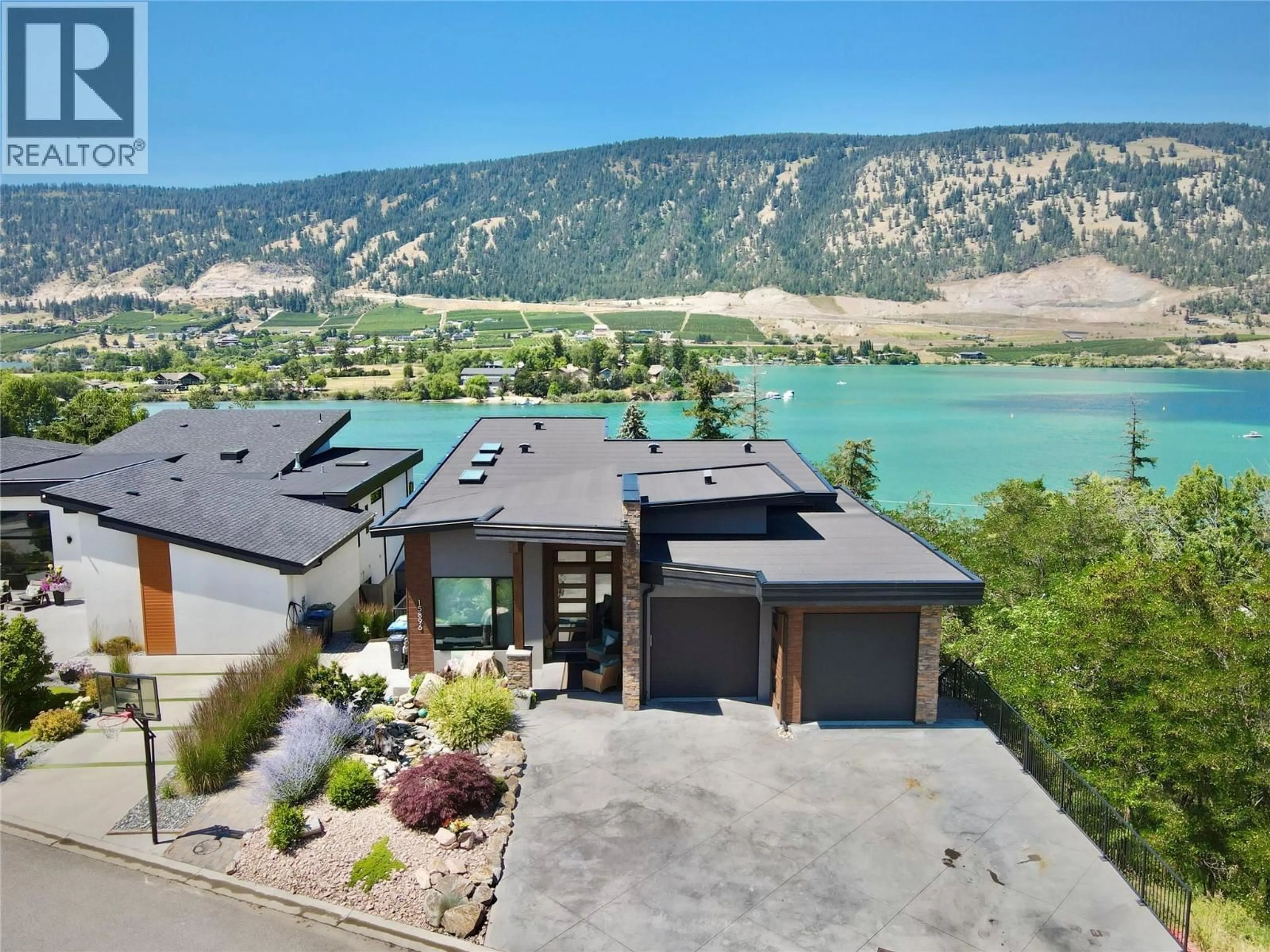 A pic from outside/outdoor area/front of a property/back of a property/a pic from drone, water/lake/river/ocean view for 15896 CLARIDGE DRIVE, Lake Country British Columbia V4V2T6
