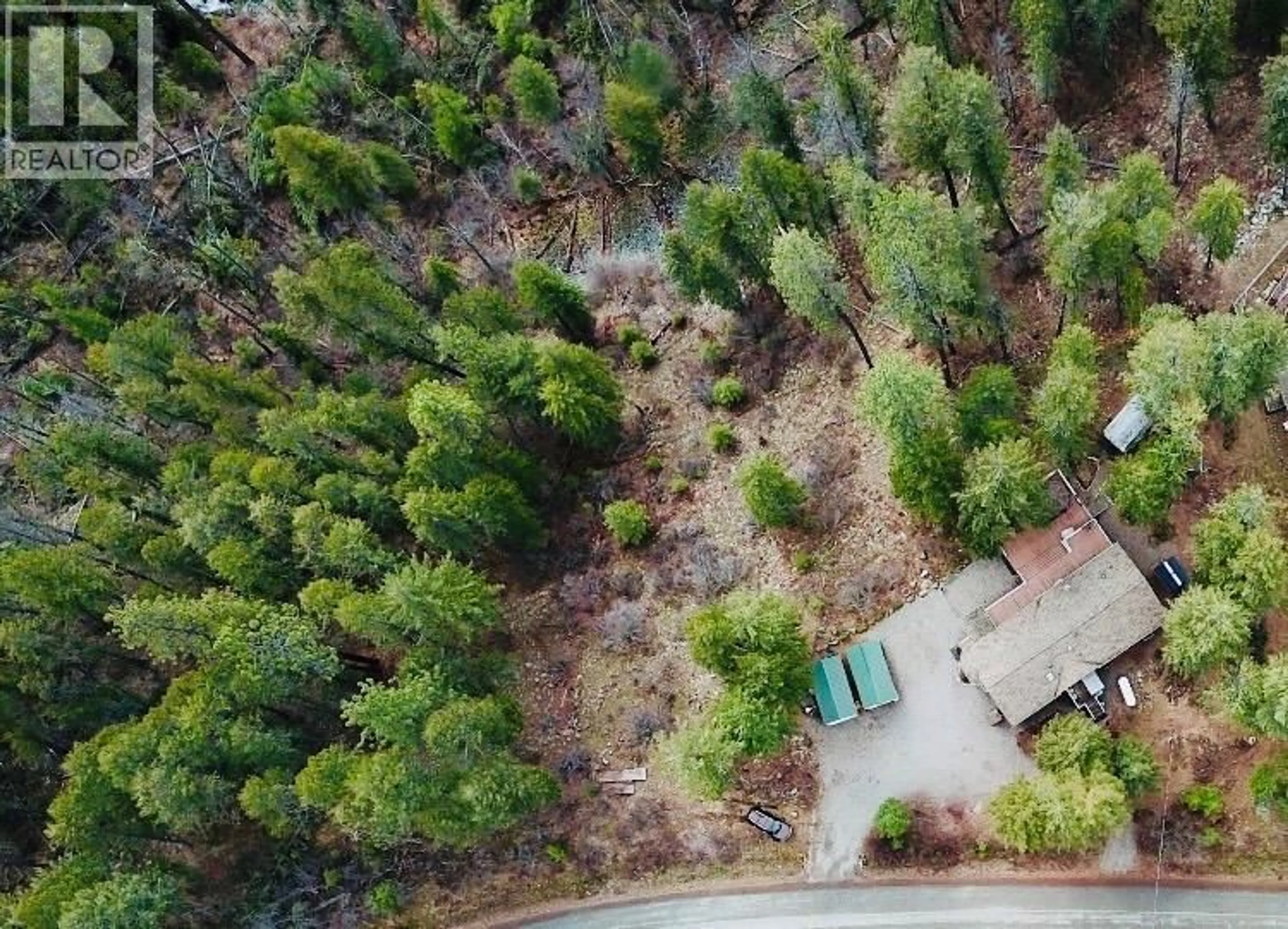 A pic from outside/outdoor area/front of a property/back of a property/a pic from drone, forest/trees view for 7743 MCRAE ROAD, Christina Lake British Columbia V0H1E0