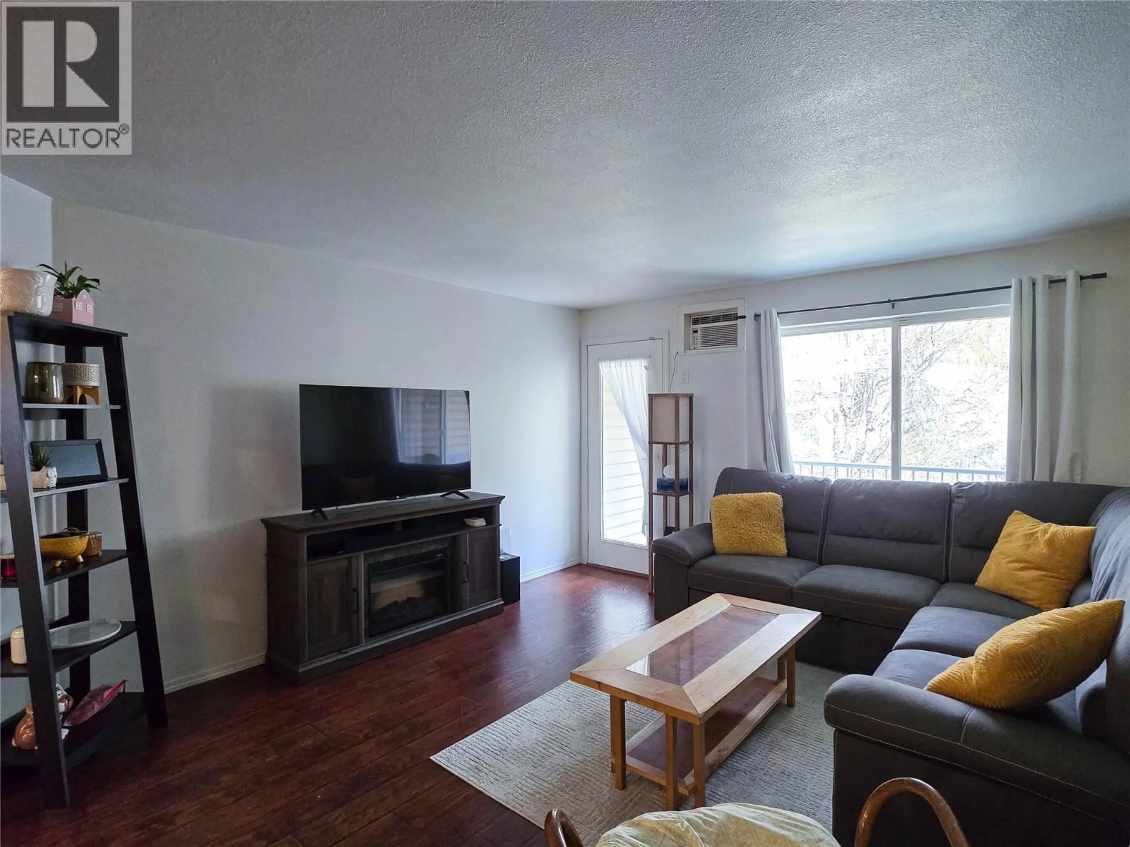 Living room with furniture, wood/laminate floor for 208 - 110 KALAMALKA LAKE ROAD, Vernon British Columbia V1T7M3