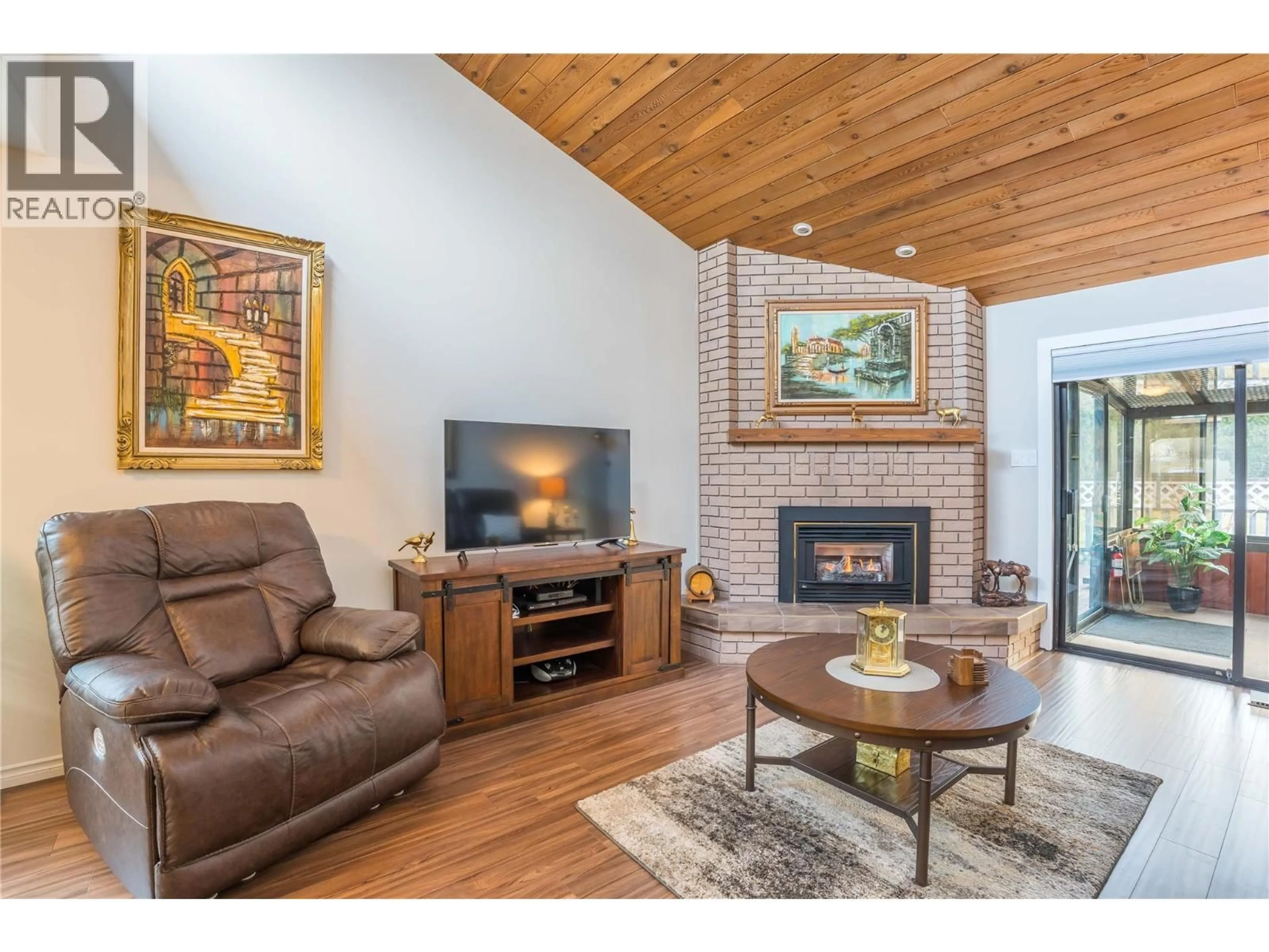 Living room with furniture, wood/laminate floor for 101 - 7717 PRAIRIE VALLEY ROAD, Summerland British Columbia V0H1Z4