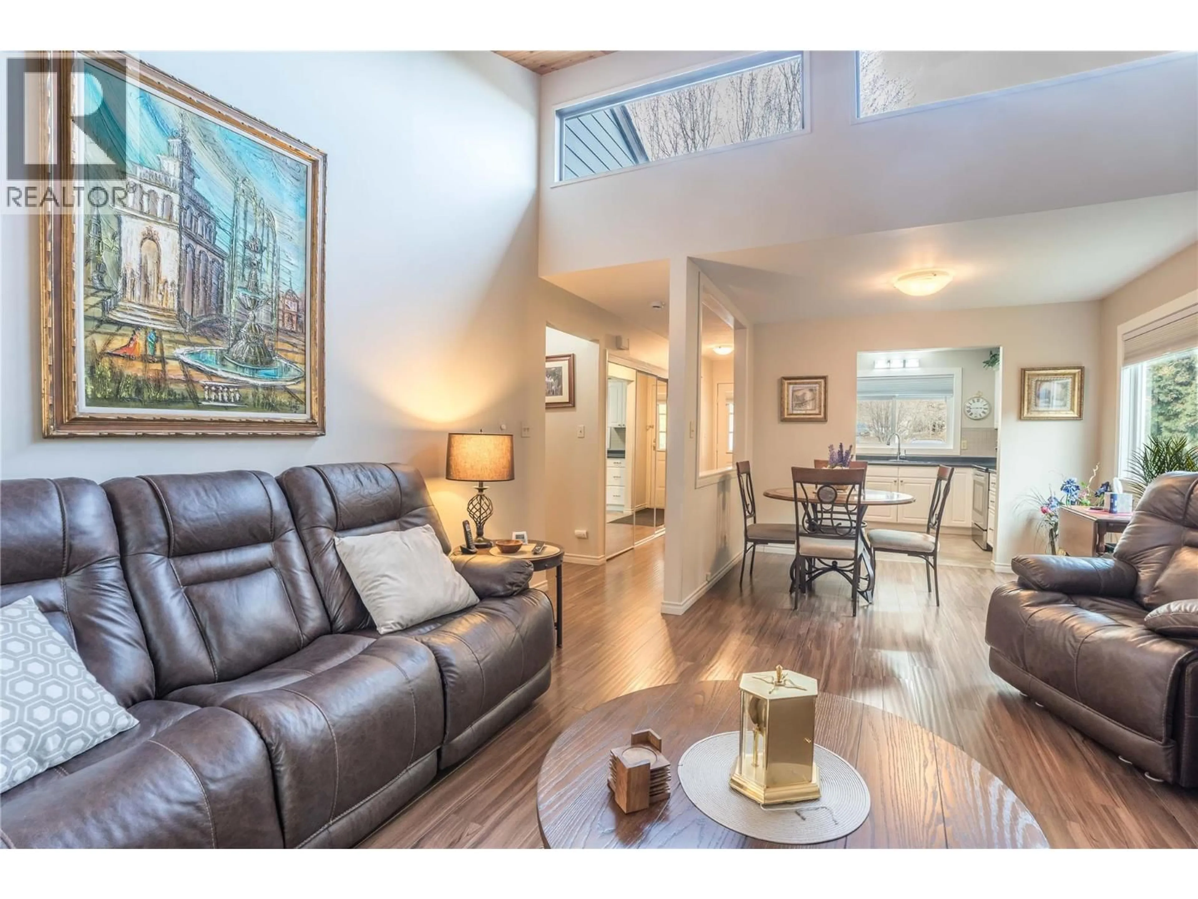 Living room with furniture, wood/laminate floor for 101 - 7717 PRAIRIE VALLEY ROAD, Summerland British Columbia V0H1Z4