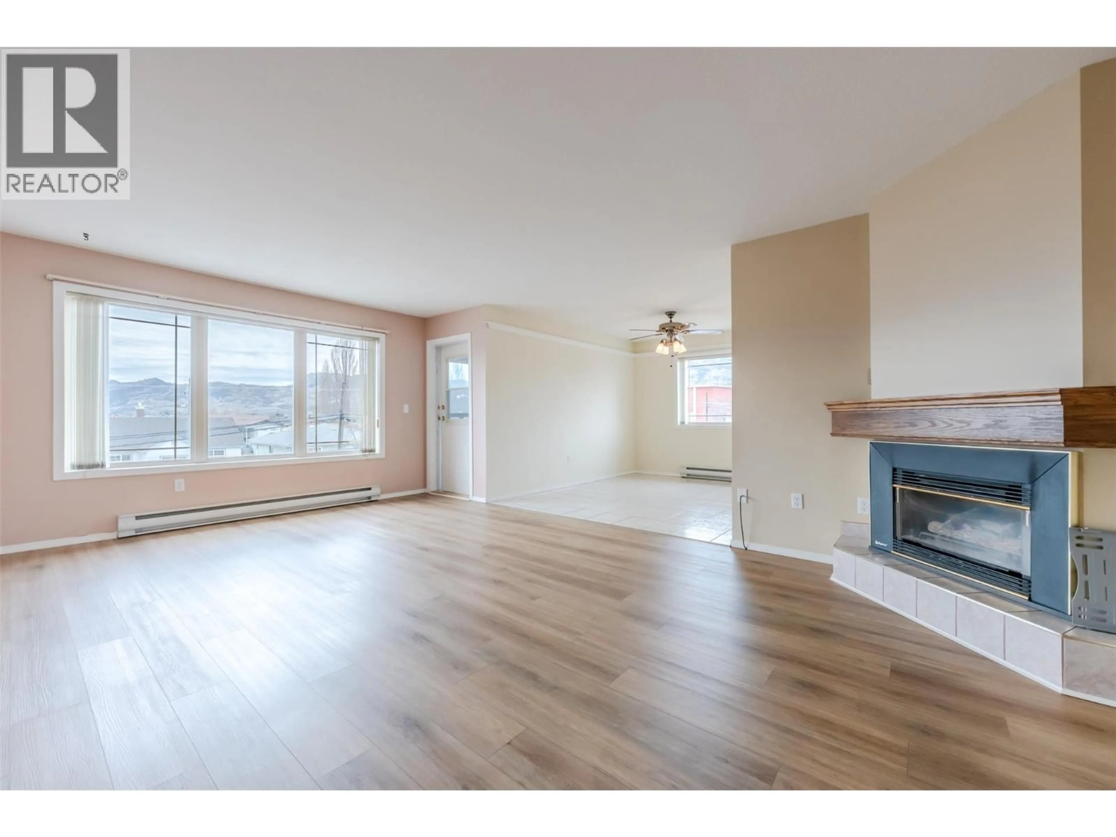 Living room with furniture, wood/laminate floor for 301 - 8302 68 AVENUE, Osoyoos British Columbia V0H1V7
