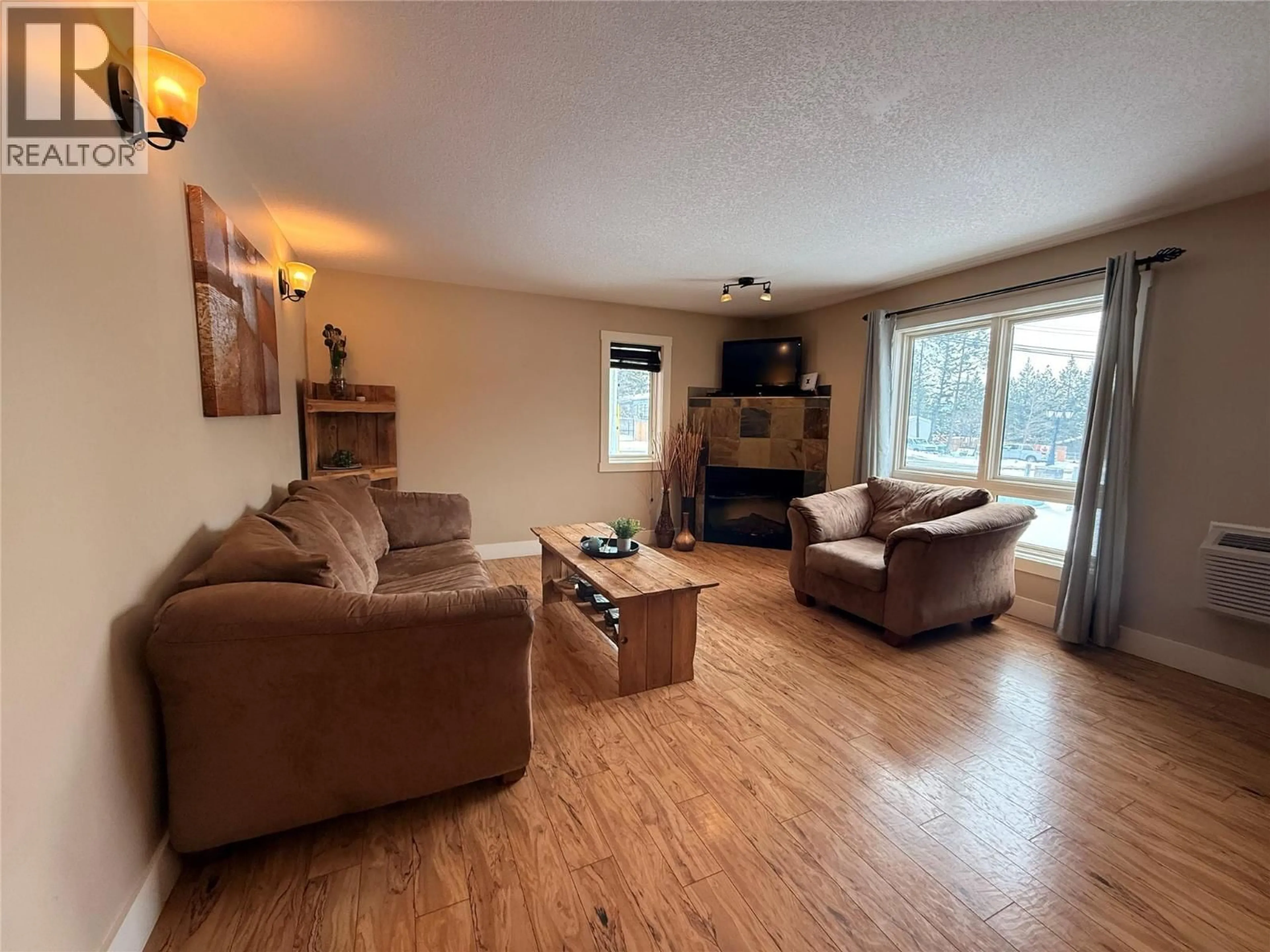 Living room with furniture, wood/laminate floor for 701 - 7337 PROSPECTOR AVENUE, Radium Hot Springs British Columbia V0A1M0
