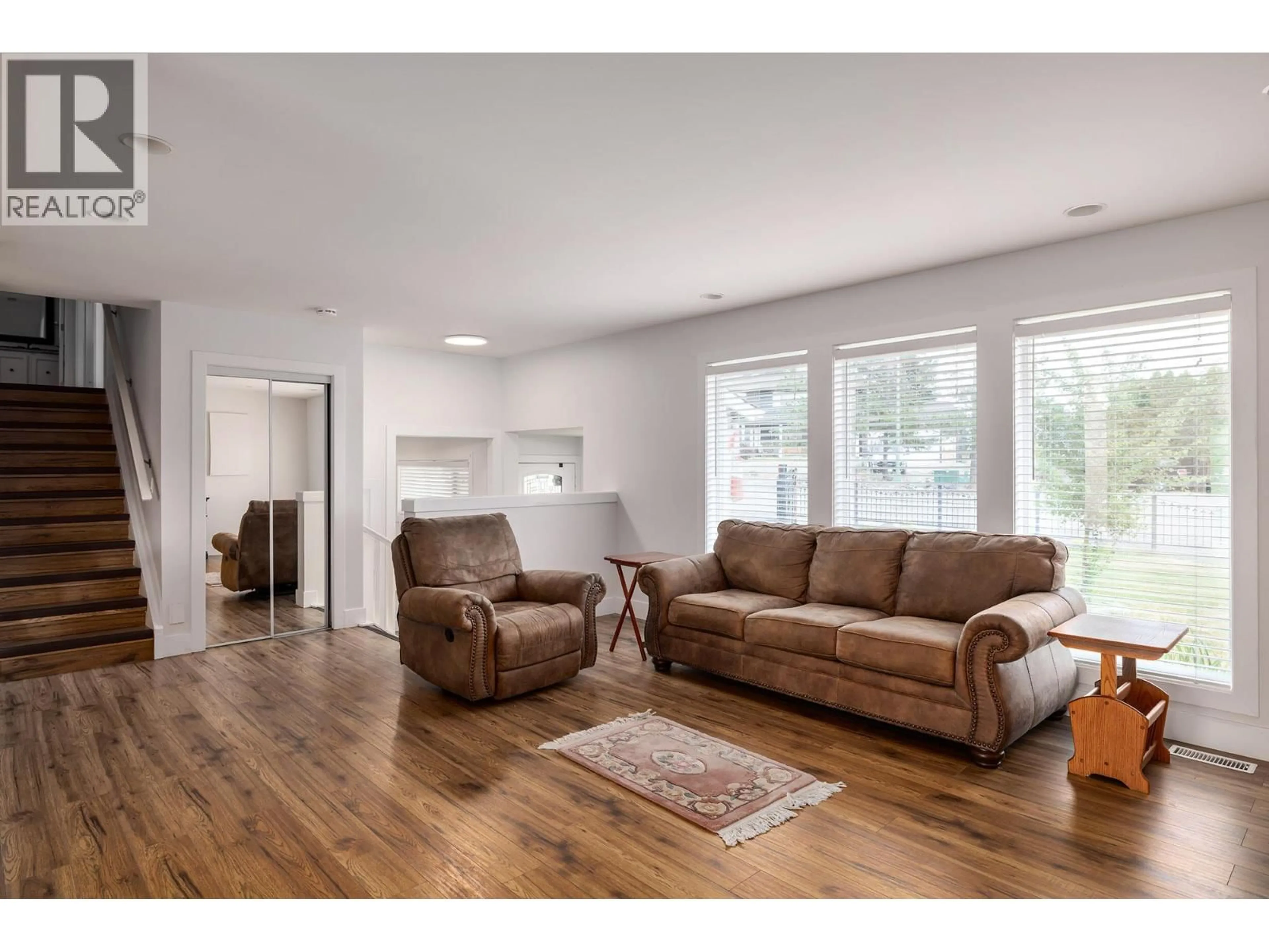 Living room with furniture, wood/laminate floor for 2571 PINERIDGE PLACE, West Kelowna British Columbia V4T2J7