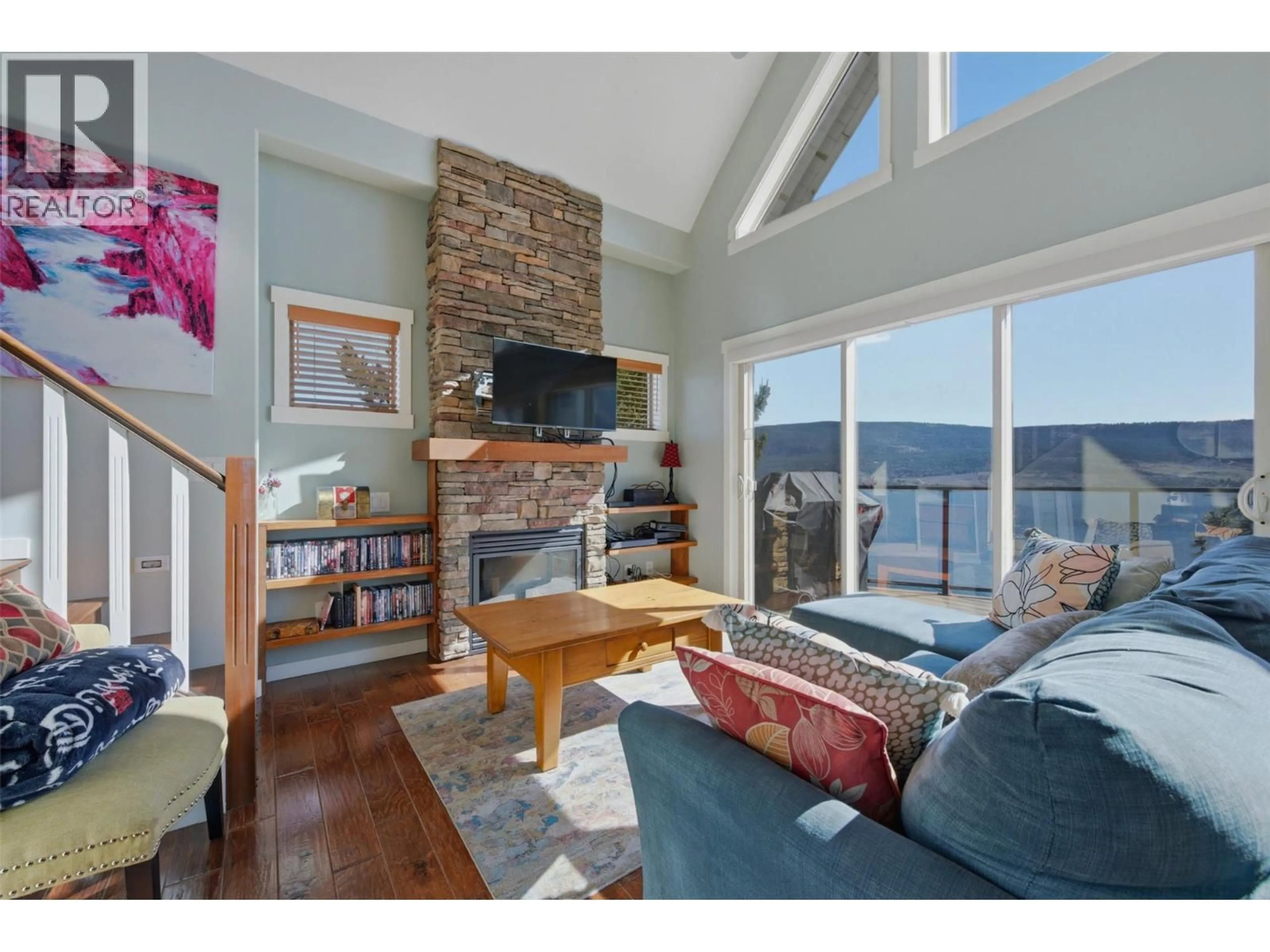 Living room with furniture, wood/laminate floor for 6904 BARCELONA DRIVE, Kelowna British Columbia V1Z3R8