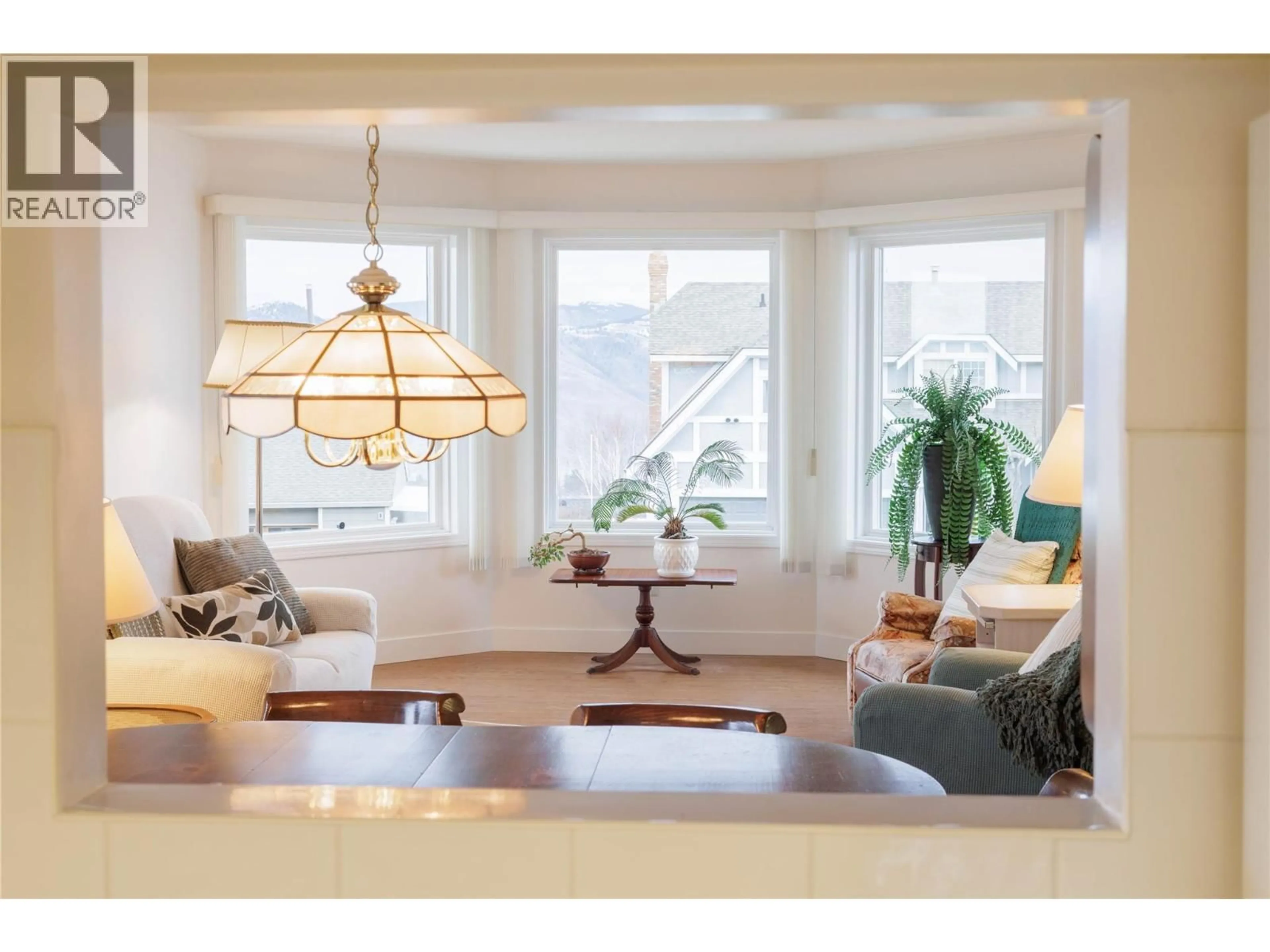 Living room with furniture, wood/laminate floor for 2158 GARYMEDE DRIVE, Kamloops British Columbia V1S1N9