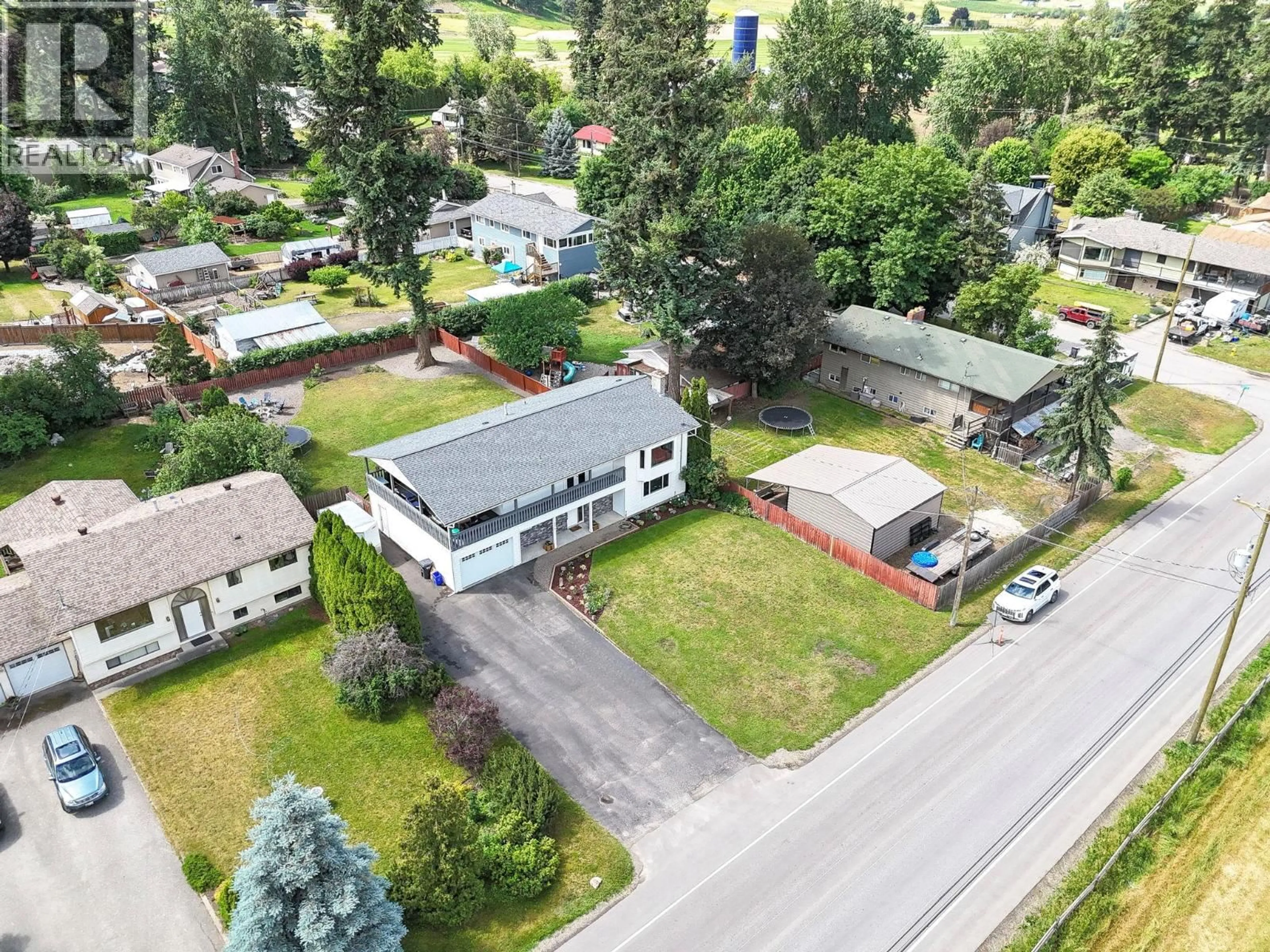 A pic from outside/outdoor area/front of a property/back of a property/a pic from drone, street for 6274 LEARMOUTH ROAD, Coldstream British Columbia V1B3G1