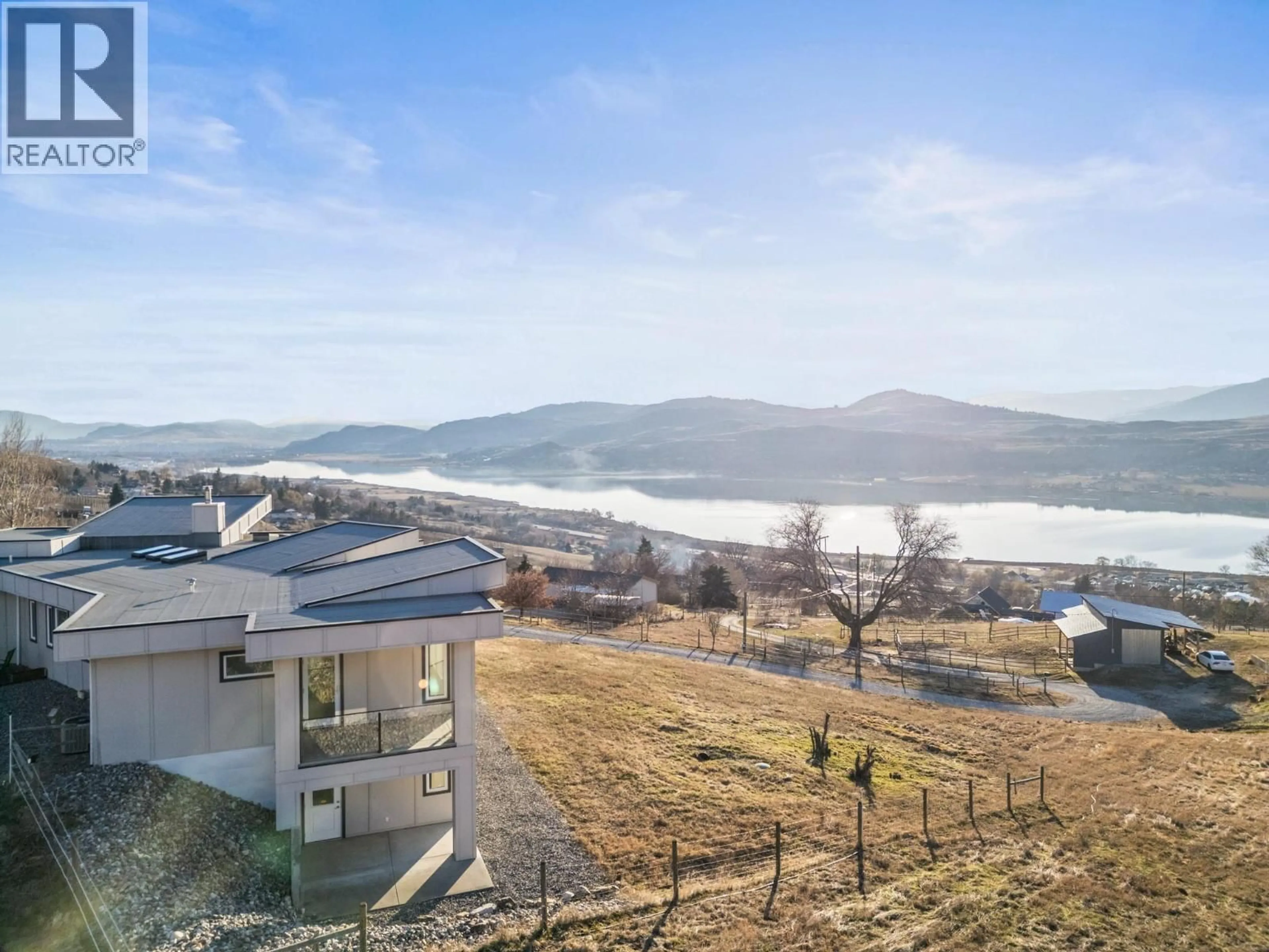 A pic from outside/outdoor area/front of a property/back of a property/a pic from drone, mountain view for 7697 BAKER HOGG ROAD, Vernon British Columbia V1B3S3