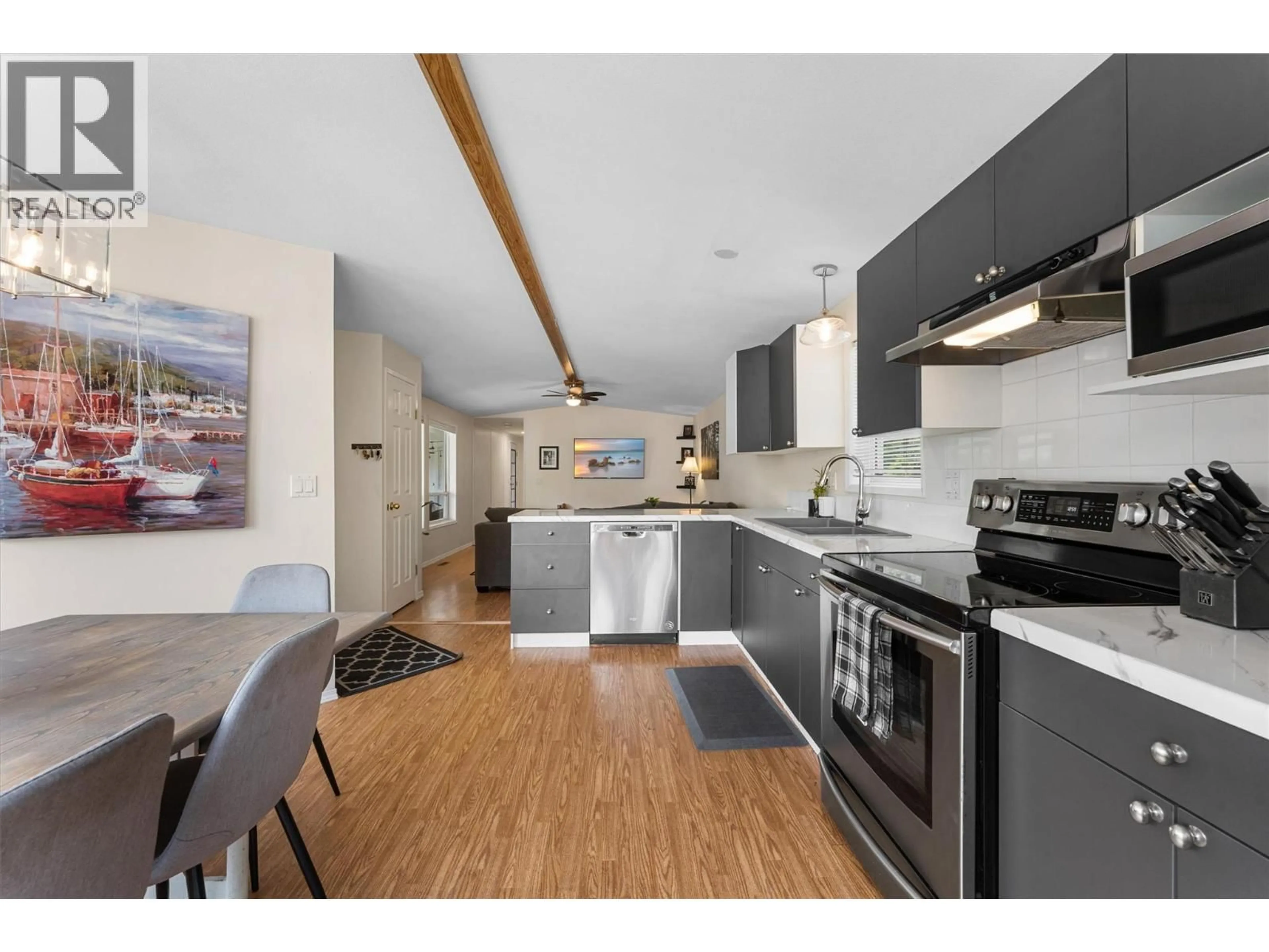 Open concept kitchen, wood/laminate floor for 101 - 1699 ROSS ROAD, West Kelowna British Columbia V1Z1L8