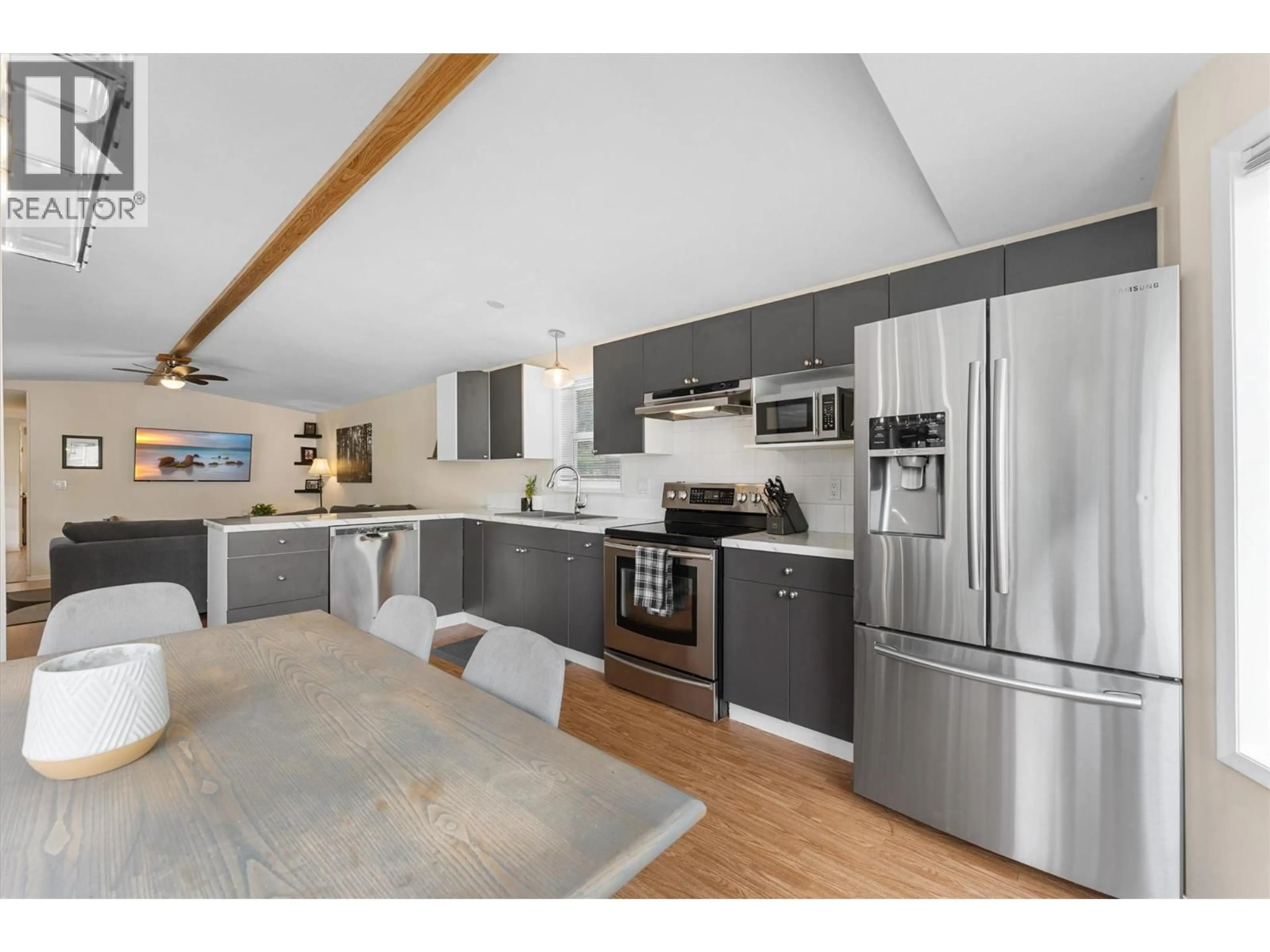 Open concept kitchen, wood/laminate floor for 101 - 1699 ROSS ROAD, West Kelowna British Columbia V1Z1L8