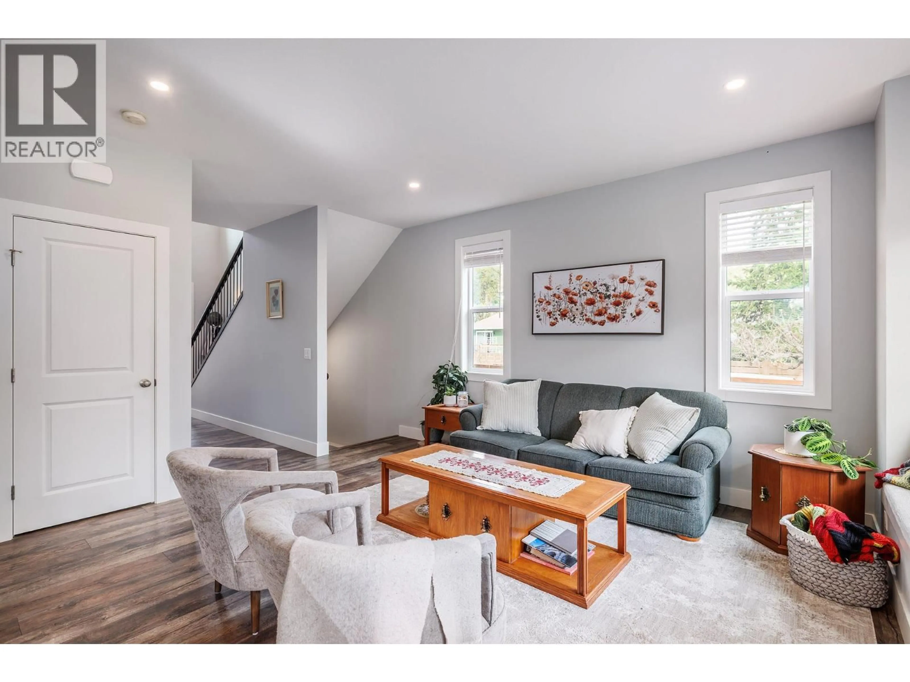 Living room with furniture, wood/laminate floor for 1259 RIO DRIVE, Kelowna British Columbia V1V1E2