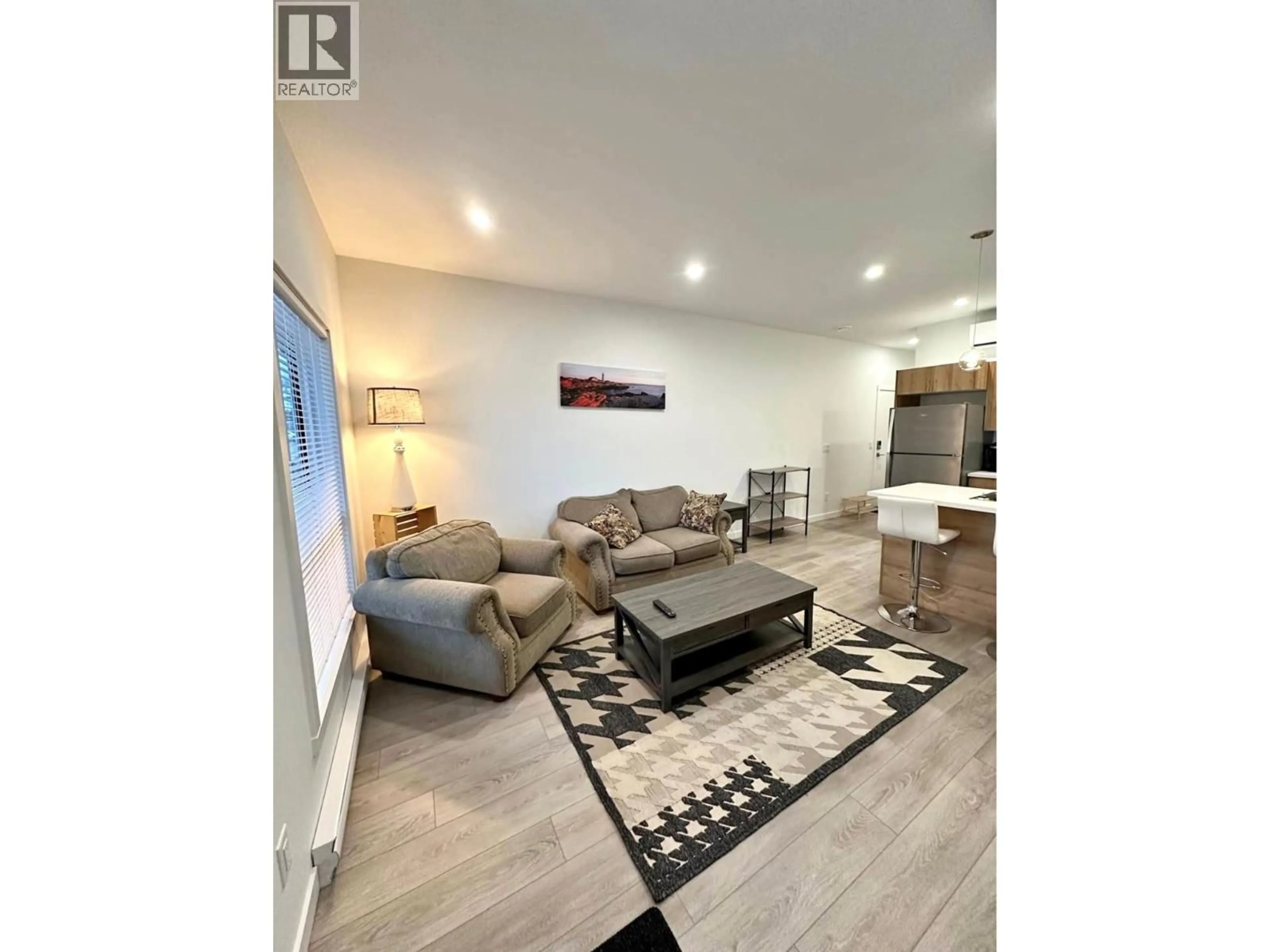 Living room with furniture, wood/laminate floor for 144 - 8900 JIM BAILEY ROAD, Kelowna British Columbia V4V0B5