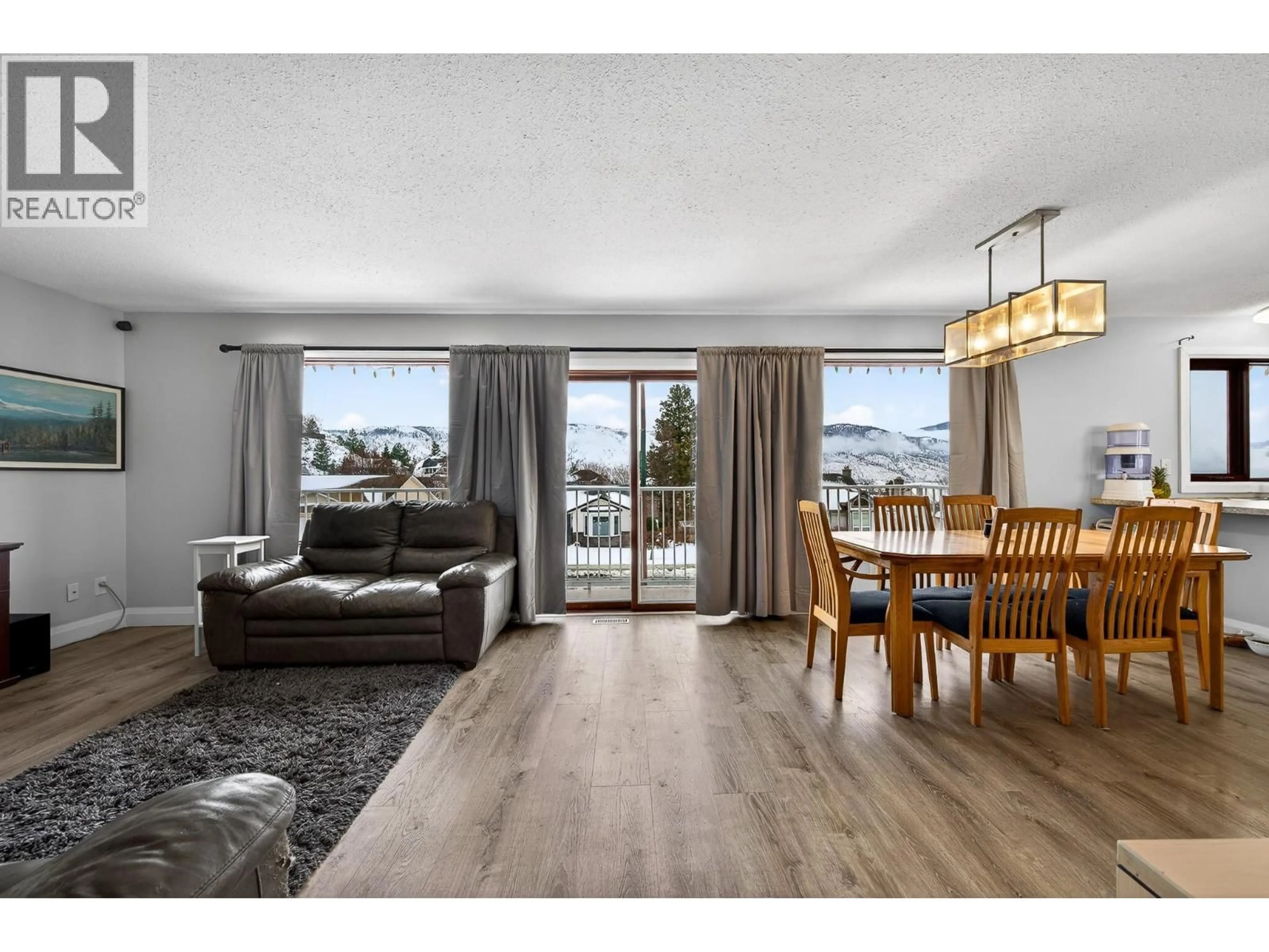 Living room with furniture, wood/laminate floor for 2727 QU'APPELLE BOULEVARD, Kamloops British Columbia V2E2J9