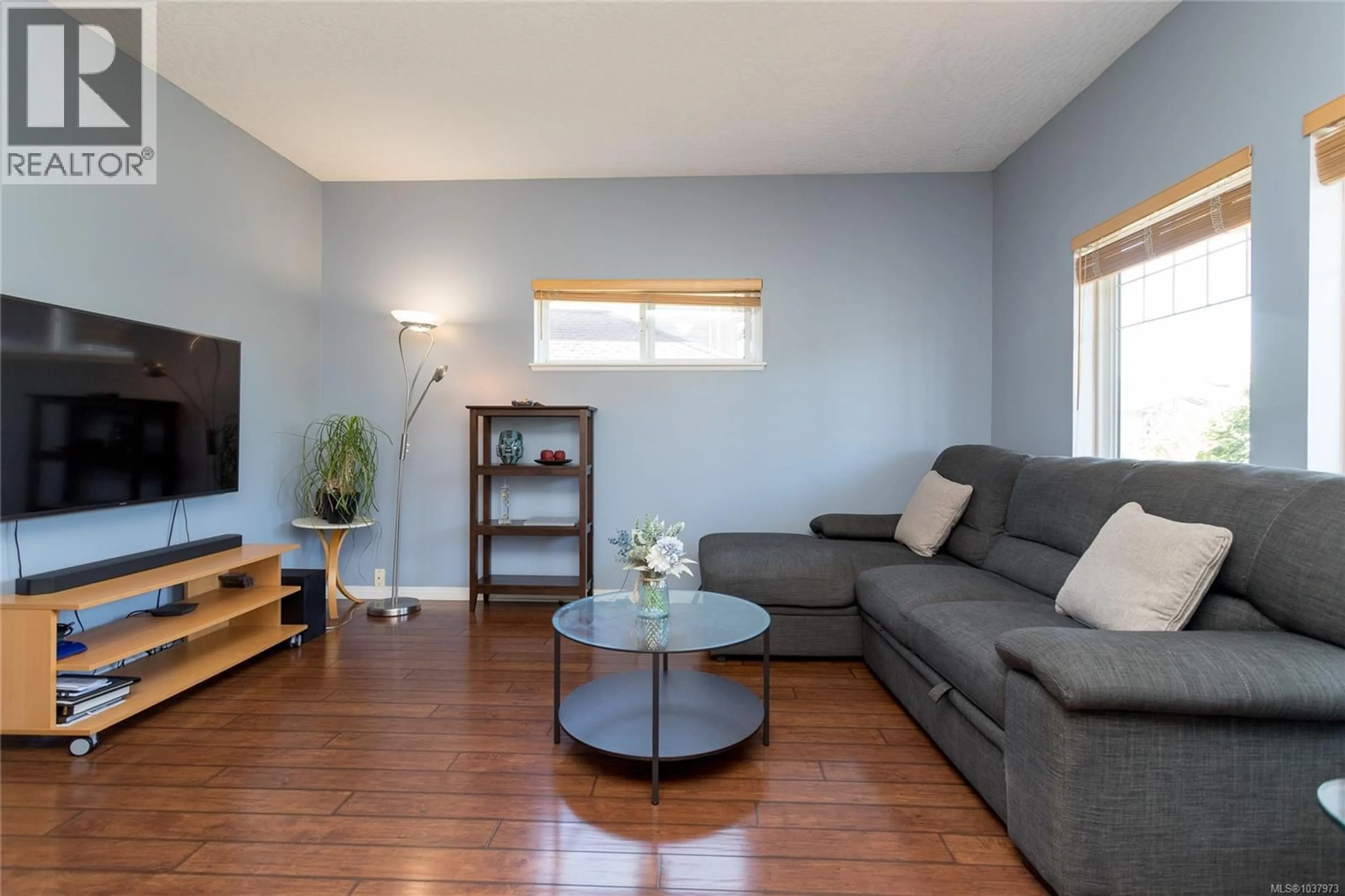 Living room with furniture, wood/laminate floor for 4021 BLACKBERRY LANE, Saanich British Columbia V8X5J4