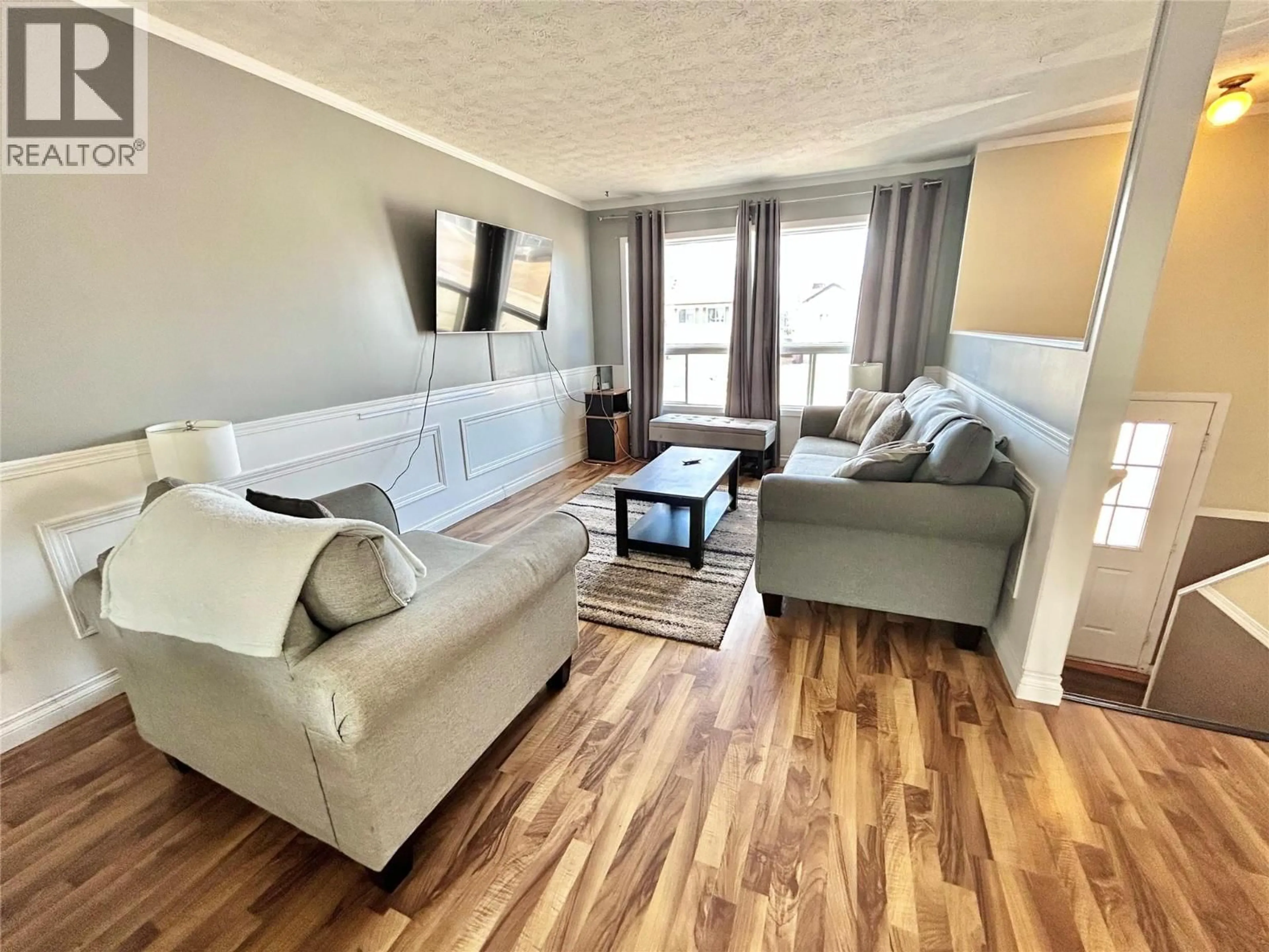 Living room with furniture, wood/laminate floor for 116 WOLVERINE AVENUE, Tumbler Ridge British Columbia V0C2W0