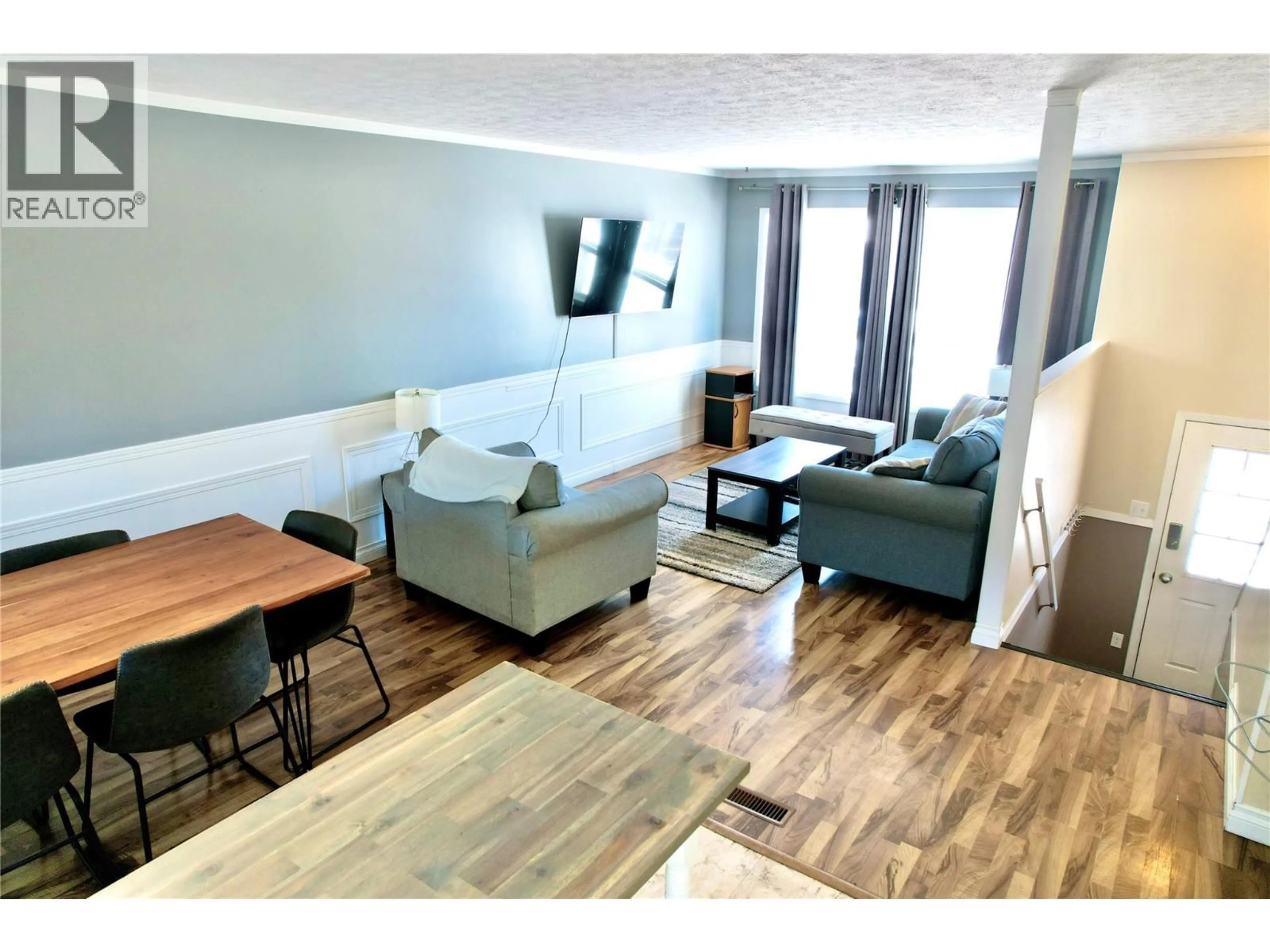 Living room with furniture, wood/laminate floor for 116 WOLVERINE AVENUE, Tumbler Ridge British Columbia V0C2W0