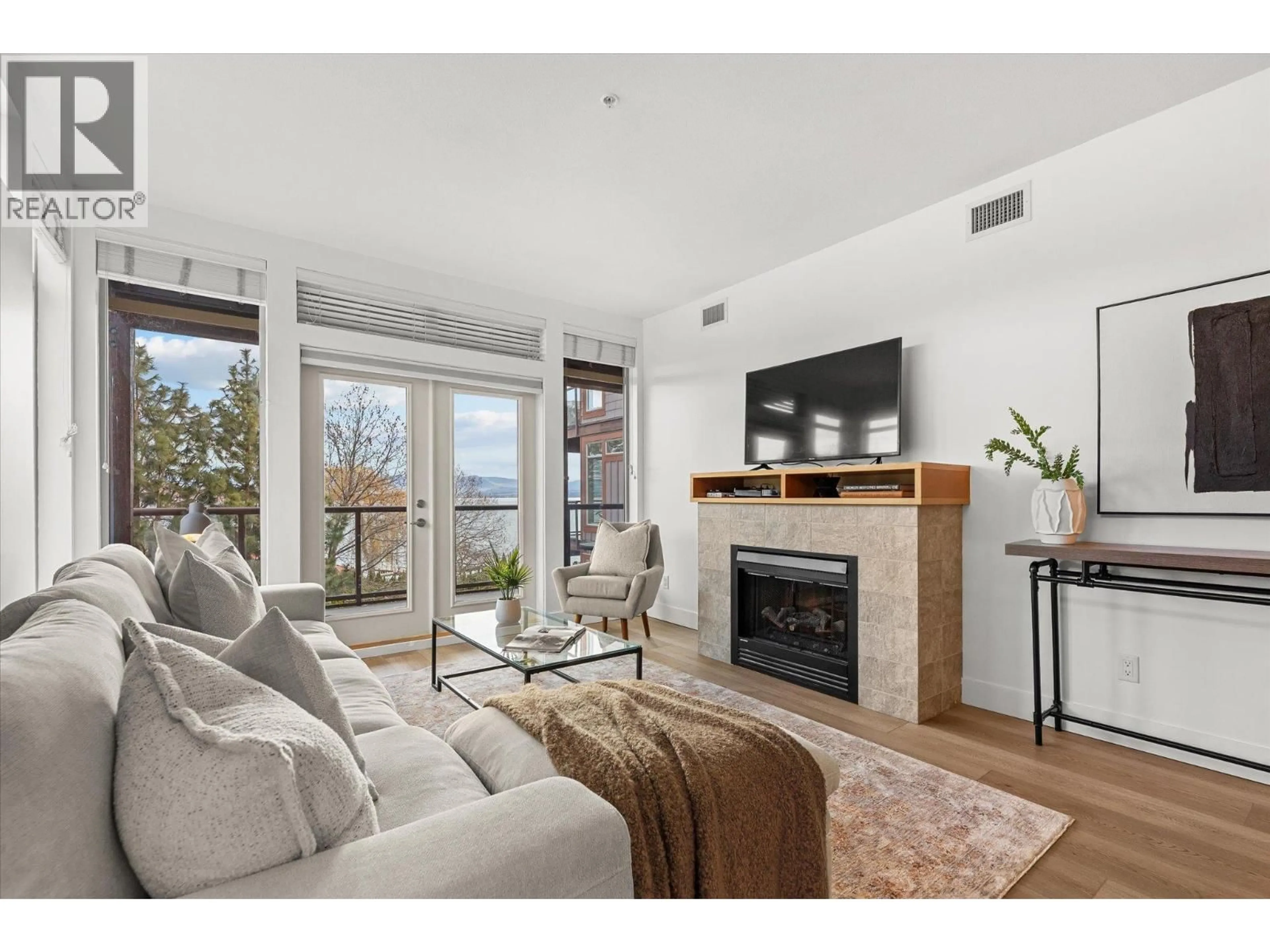 Living room with furniture, wood/laminate floor for 305 - 4205 GELLATLY ROAD, West Kelowna British Columbia V4T2K2