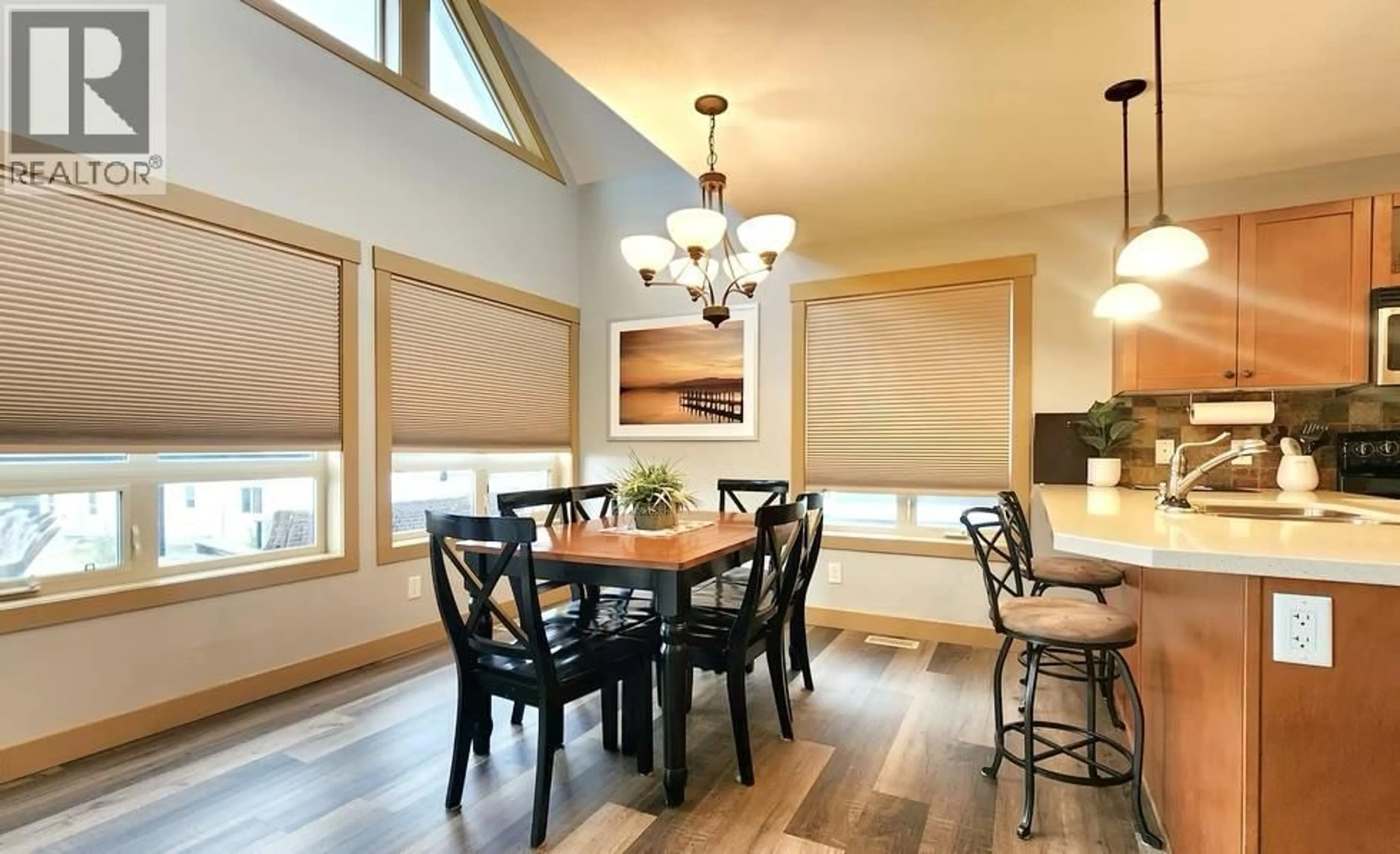 Dining room, wood/laminate floor for 321 - 6844 MADRID WAY, Fintry British Columbia V1Z3R8